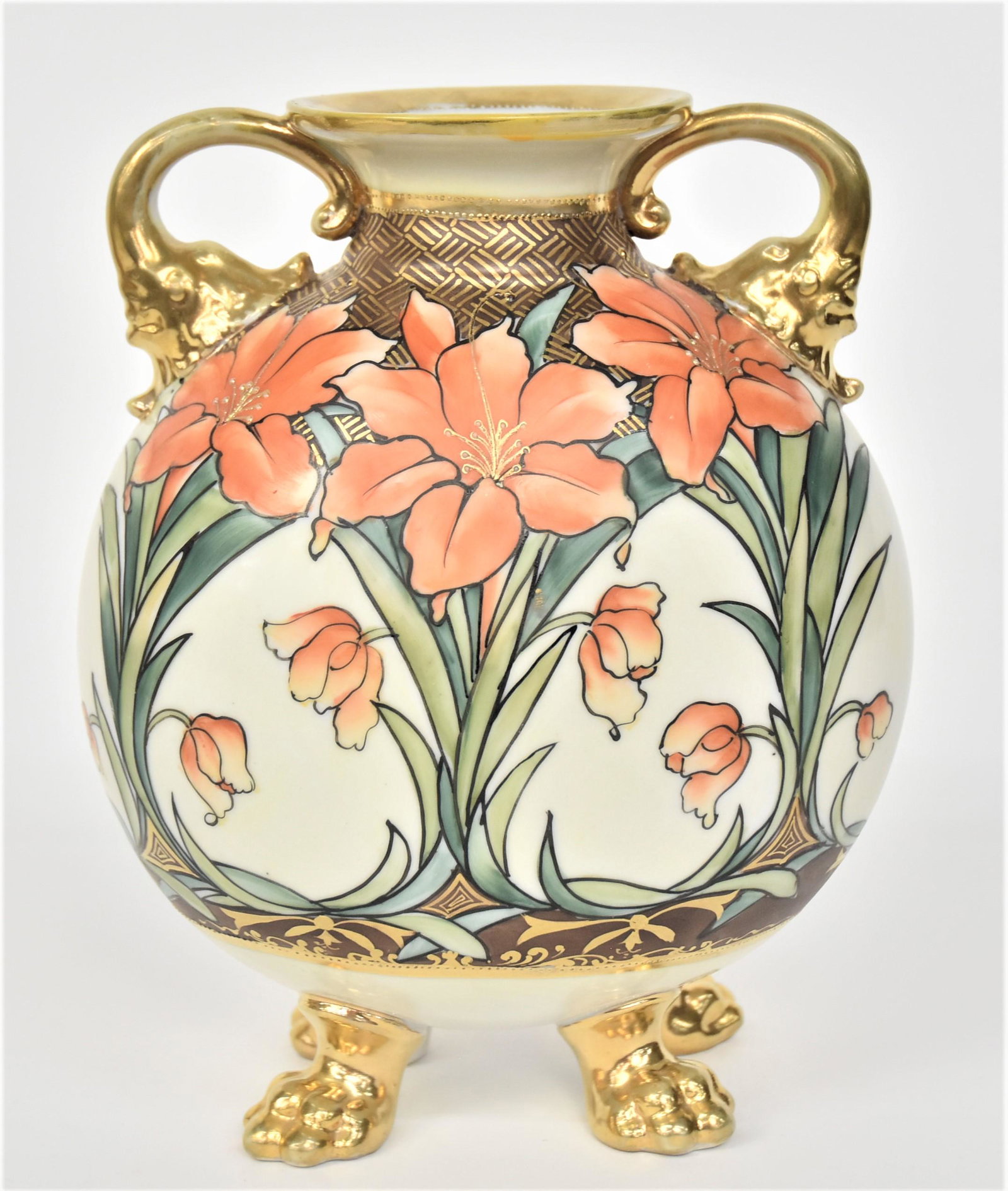 Nippon Orange Lily Vase: having gold dolphin handles & four mammal feet. Decorative trim. 8 1/4”T. 6 3/4”W. Gold has handling wear. Very good condition. Green mark.