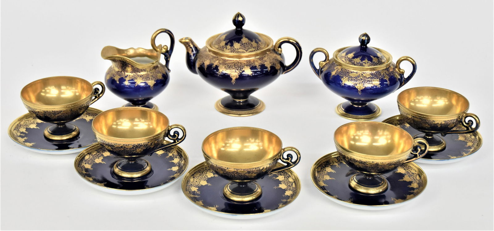Great Nippon Cobalt Blue & Gold Pedestaled Tea Set: Consisting 5 3/4” covered tea pot, 4 3/4” covered sugar bowl, 4 3/4” creamer, five 2 1/2” cups & five 5 1/2” saucers. Impressive set. Very good condition. Green marks to