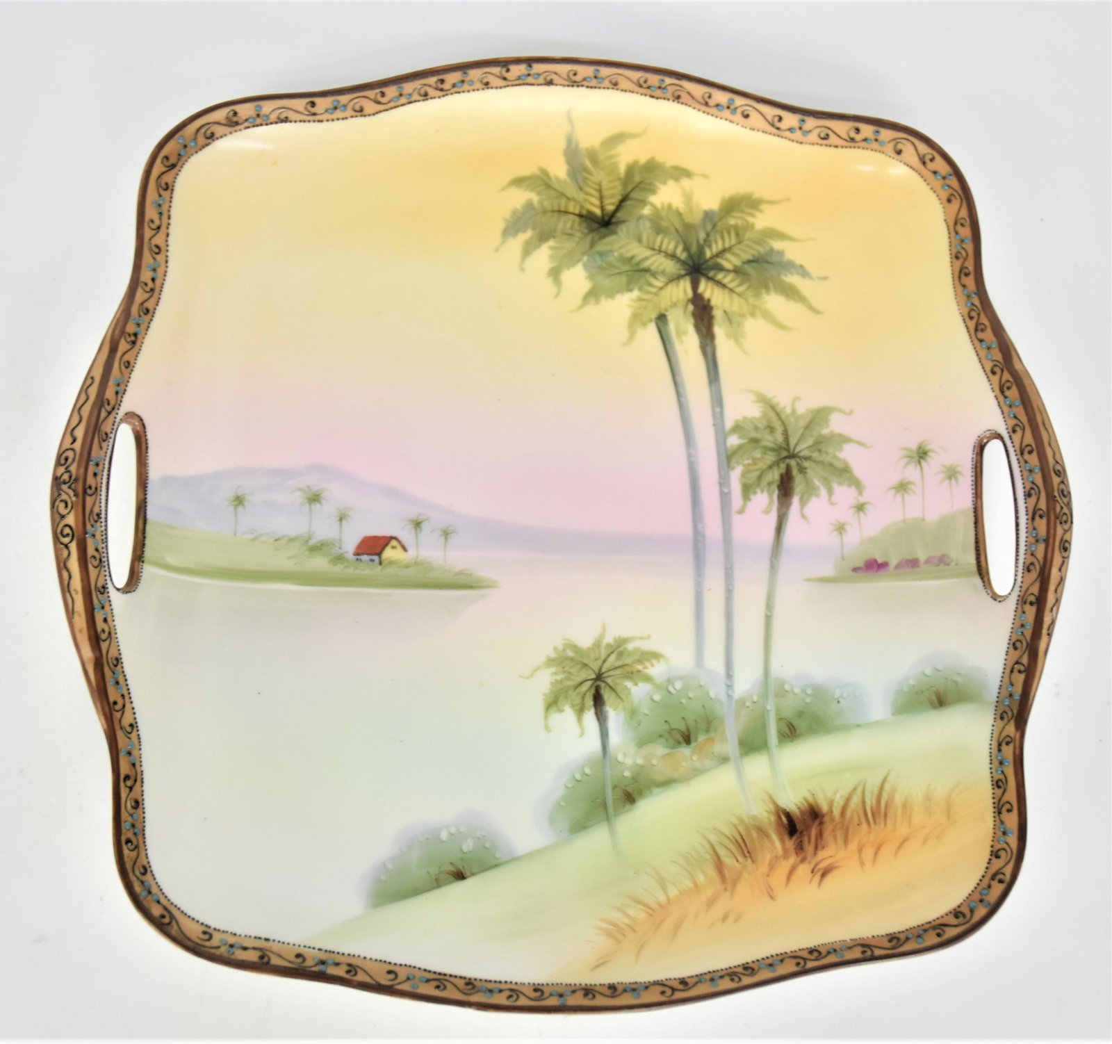 Nippon Squared Cake Plate With Punch Handles: Lake view of palm trees & a coastal home. Nice bead & scroll border. Very good condition. Blue mark.