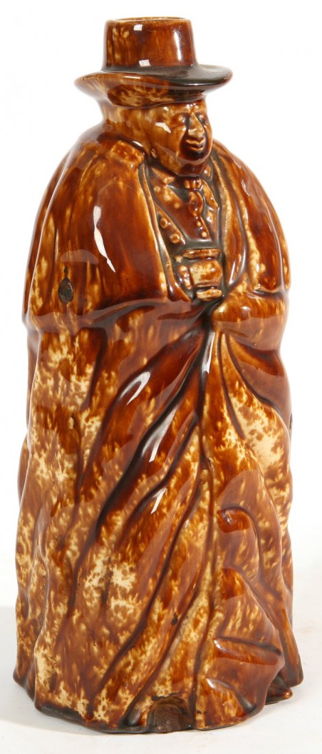 BENNINGTON TOBY COACHMAN FIGURAL BOTTLE: Rockingham glaze with type A 1849 stamp impressed mark. Chip to front foot and glaze bubbles in making. 10 1/2" h.