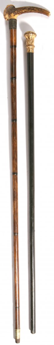TWO ANTIQUE CANES: Includes a circa 1870 with antler crook type grip, 1" chased sterling collar on stepped cane shaft with 1 1/2" nickel and steel ferrule. Total length 36". Also includes a gold filled walking stick eng