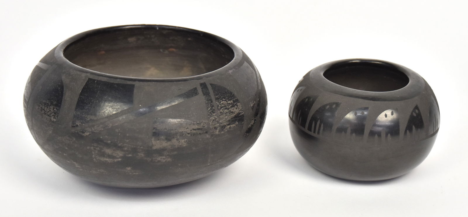 San Ildefonso Black on Black Pottery Bowl: Unsigned with geometric decoration, old paper label on base reading: Southwest U.S. Pueblo Burnished pot, 6 ¾” diameter x 3 1/3” high. Condition wear to finish, especially on lower
