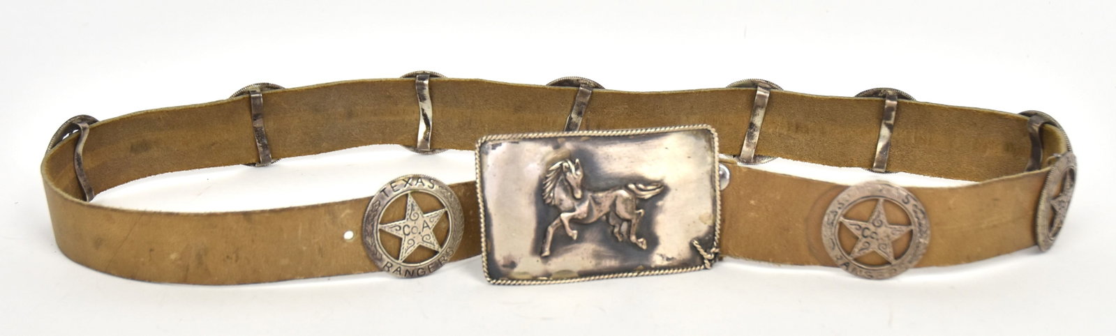 Navajo Silver Concho Belt: Artist initialed W.B./Sterling with rectangular buckle with roped edging and high relief bucking horse, belt with ten cut-out Texas Ranger Co. A badges with laurel wreaths, each 1 1/2" diameter, all o