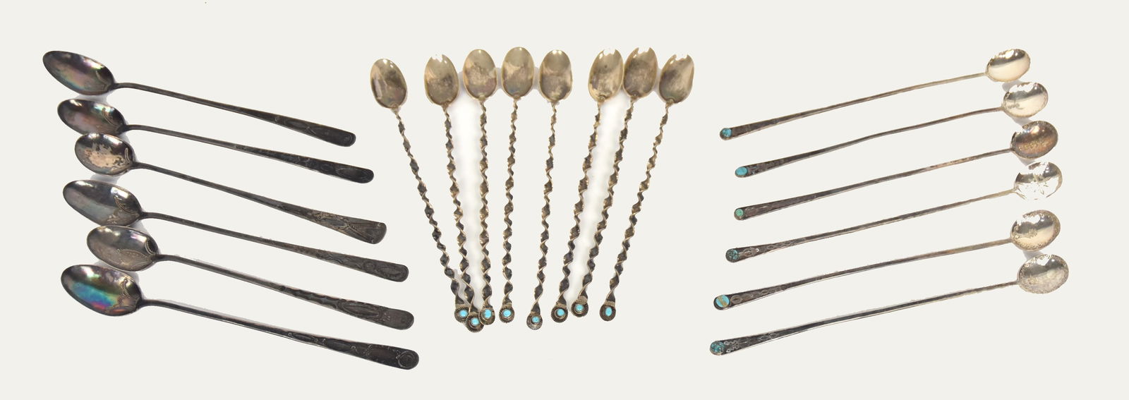 Three Sets of Navajo Silver Ice Tea Spoons: All with engraved decoration, including one set of six, 9" long; plus set of eight with twist handles and turquoise stones, 8 1/4" long; and set of six with turquoise stones, 9 1/4" long, likely all c