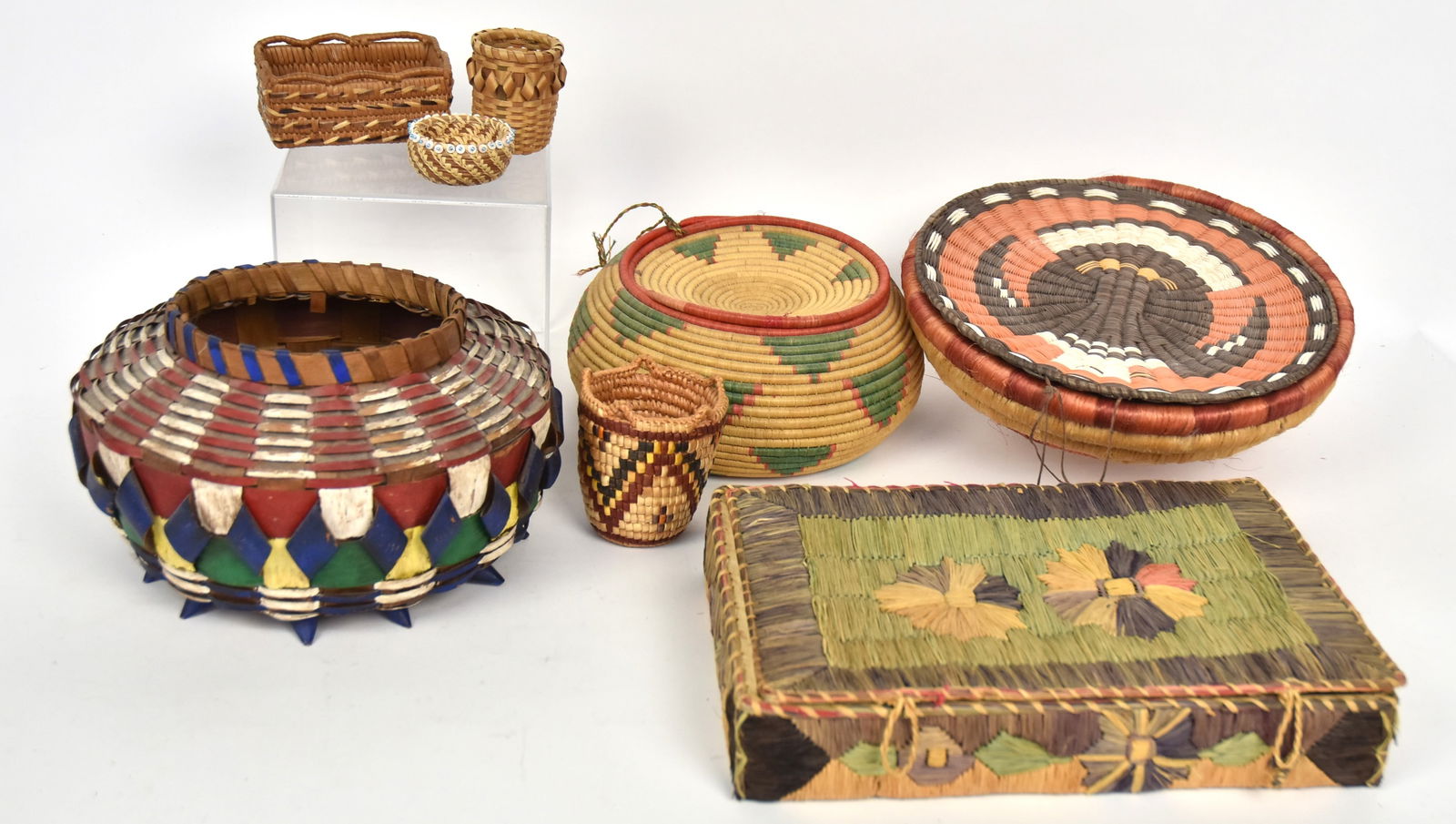 Eight Native American Baskets: Including a nice painted Great Lakes example, 9 1/2" diameter x 6" high; plus lidded SW basket, 8 1/2 x 4 1/4" high; plus Hopi plate, 10 1/2" diameter; plus lidded sewing basket, 12 1/4 x 8 x 2 1/4" h