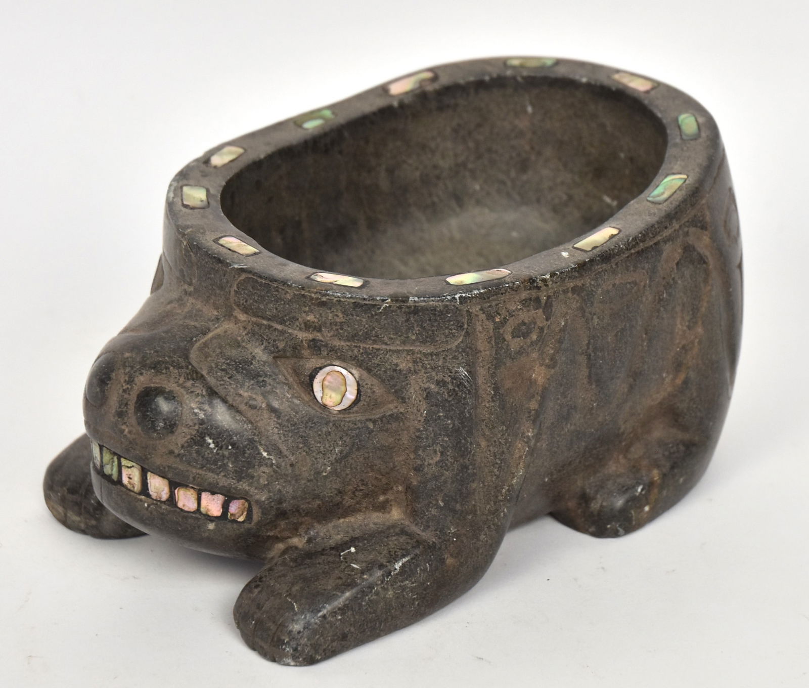 Tlingit Inlaid Stone Feast Bowl: Steatite inlaid with abalone in form of bear, 8 x 5 1/2 x 4" high. VG.