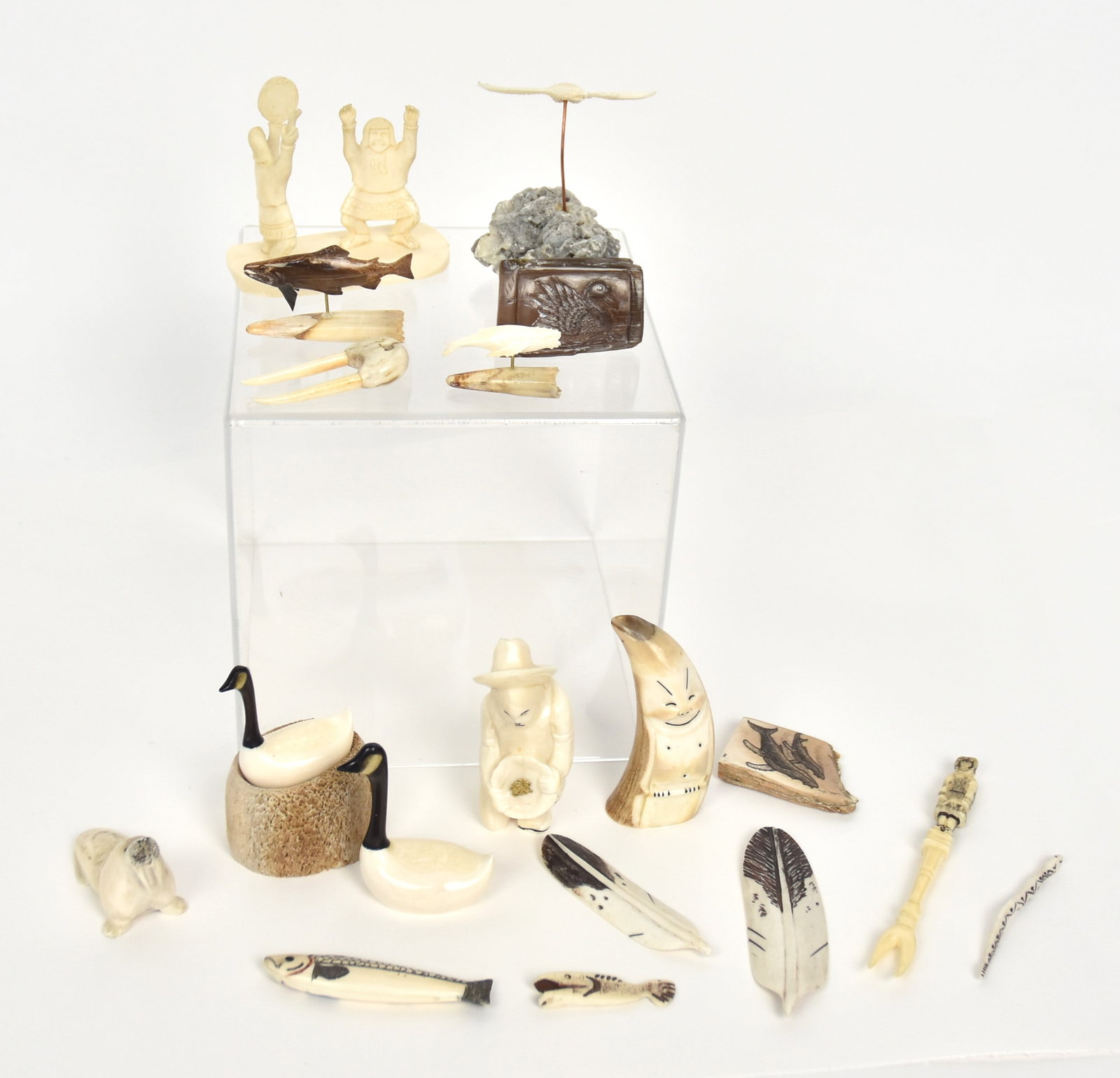 18 Inuit Bone Carvings: Including one of Gold Miner with real gold nugget in his pan, 3 1/4" high, others include geese on nest of eggs, whales, fish, walrus, eagle in flight, feathers and more, highest gold miner. Condition