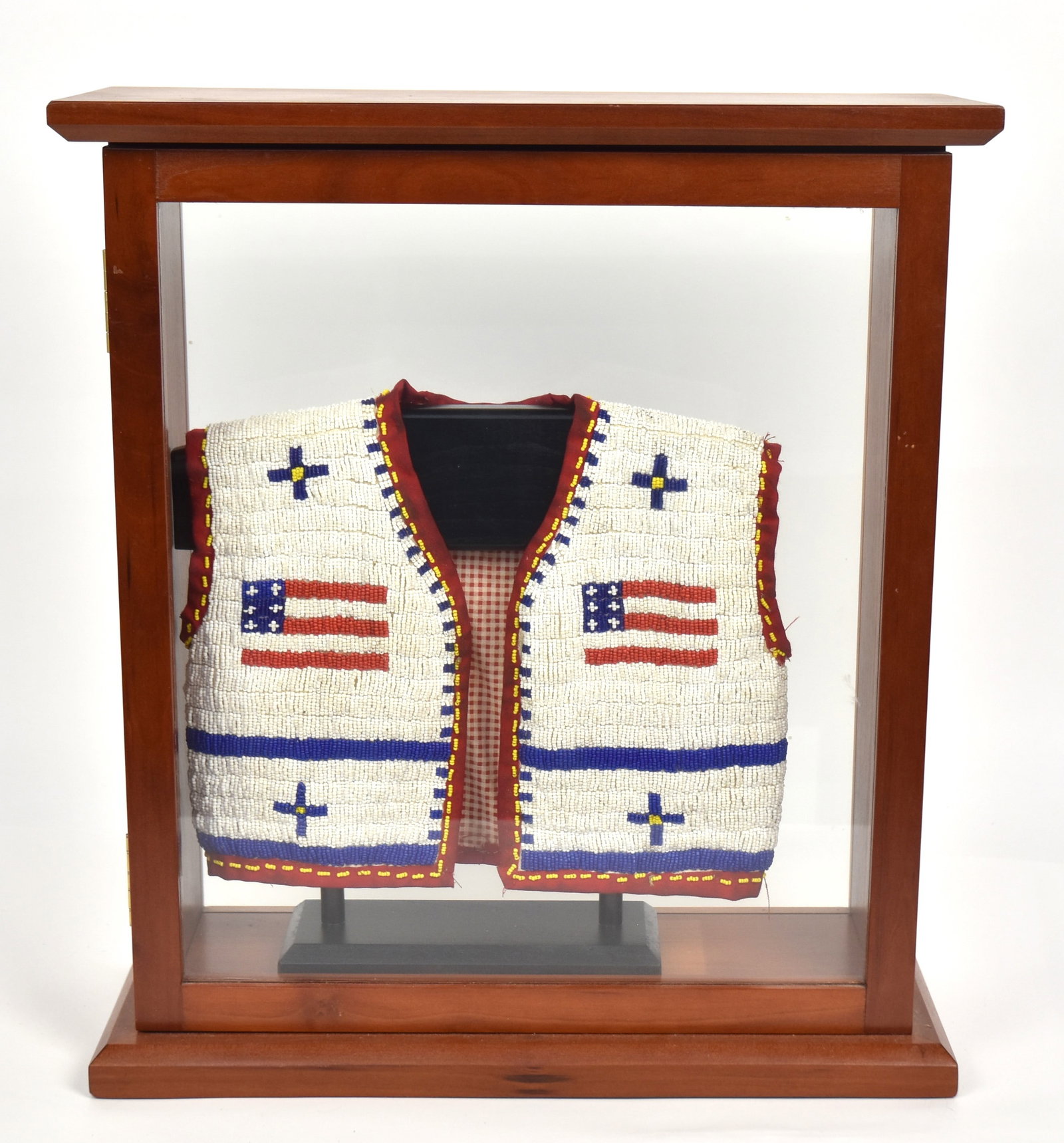 Sioux Beaded Childs Vest: first quarter of 20th century, Cotton thread sewn with red & white cotton checked liner, decorated with two flags on front and large one on back with crosses, red cotton edging and yellow bead border,