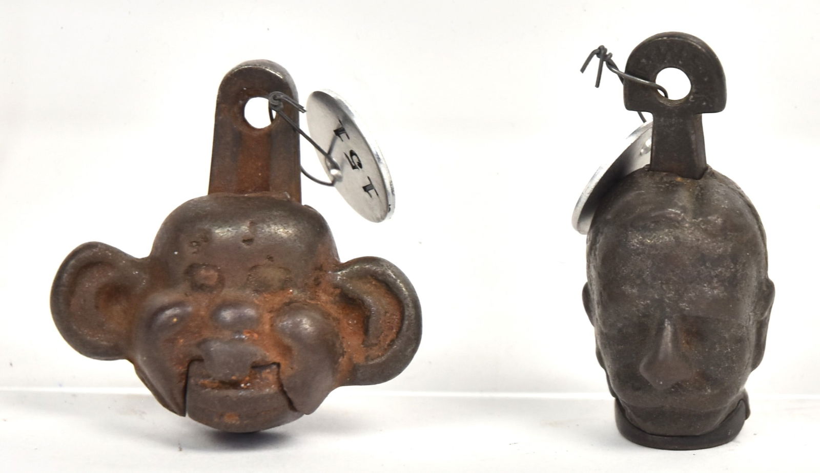 Two Rare Cast Iron Cap Bombs: Including Yellow Kid, 1 1/2" high; and Admiral Dewey, marked Dewey, 1 3/4" long. Condition VG.