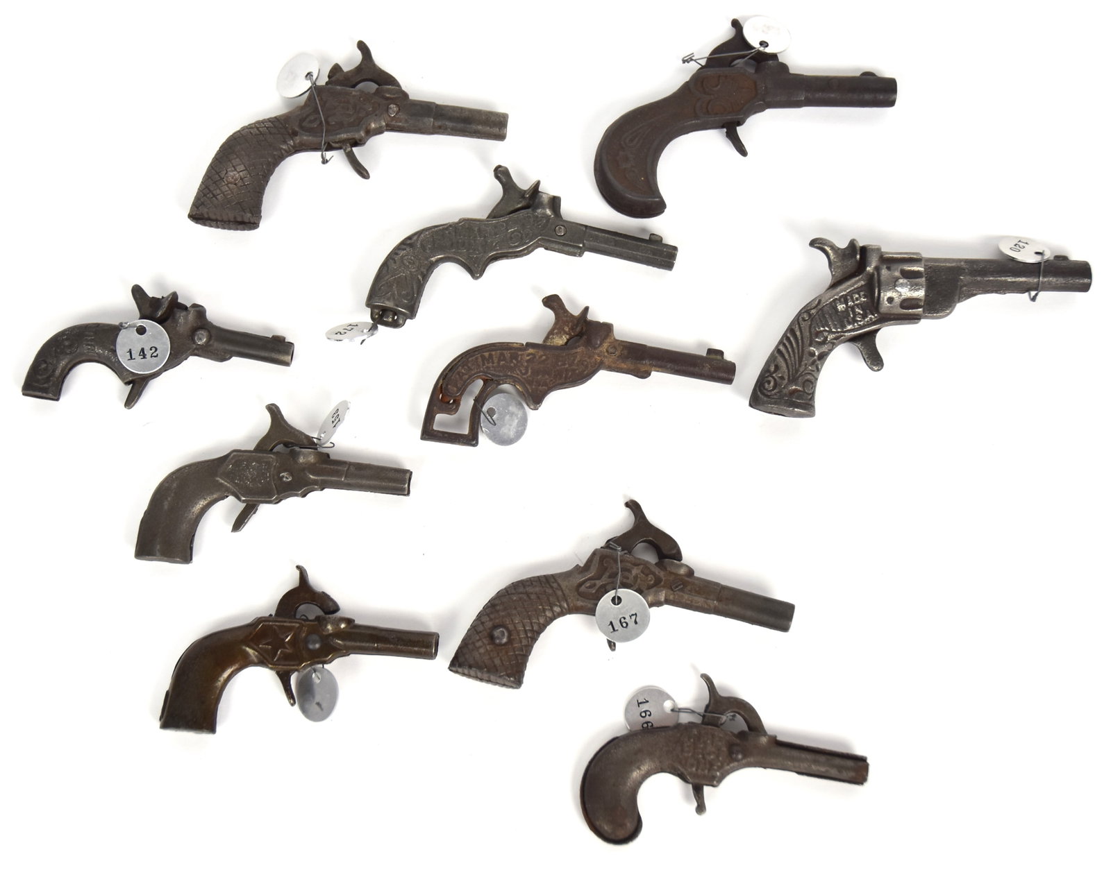 Ten Early Cast Iron Cap Guns: All percussion hammer type, including named examples: Pluck Pat. Mar 22 87 June 17 90 3 1/2" long plus Acorn Mar 22 87 June 17 USA, 3 1/2" long; plus Fox, 3" long; plus Pop with 5-pointed star, 3" lon
