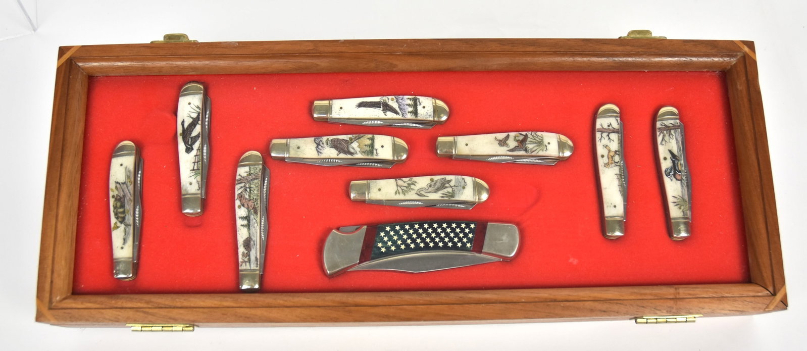 Ten Fine Pocket Knives: Including a marked Buck USA with 3 3/4" clipped end steel blade with U.S. flag motif horn & antler grips, total length open 8 1/2, closed 4 7/8"; and set of nine scrimshaw bone handled knives with goo
