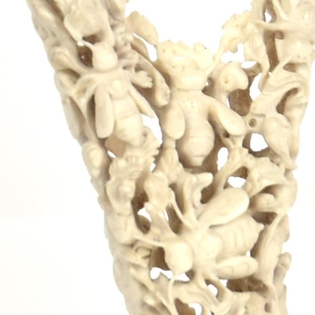 Honey Bees on Flowering Branch Antler Carving: Hollow carved deer antler, mounted on rosewood base, 3 1/4" square x 15 1/4" high. Condition Fine.