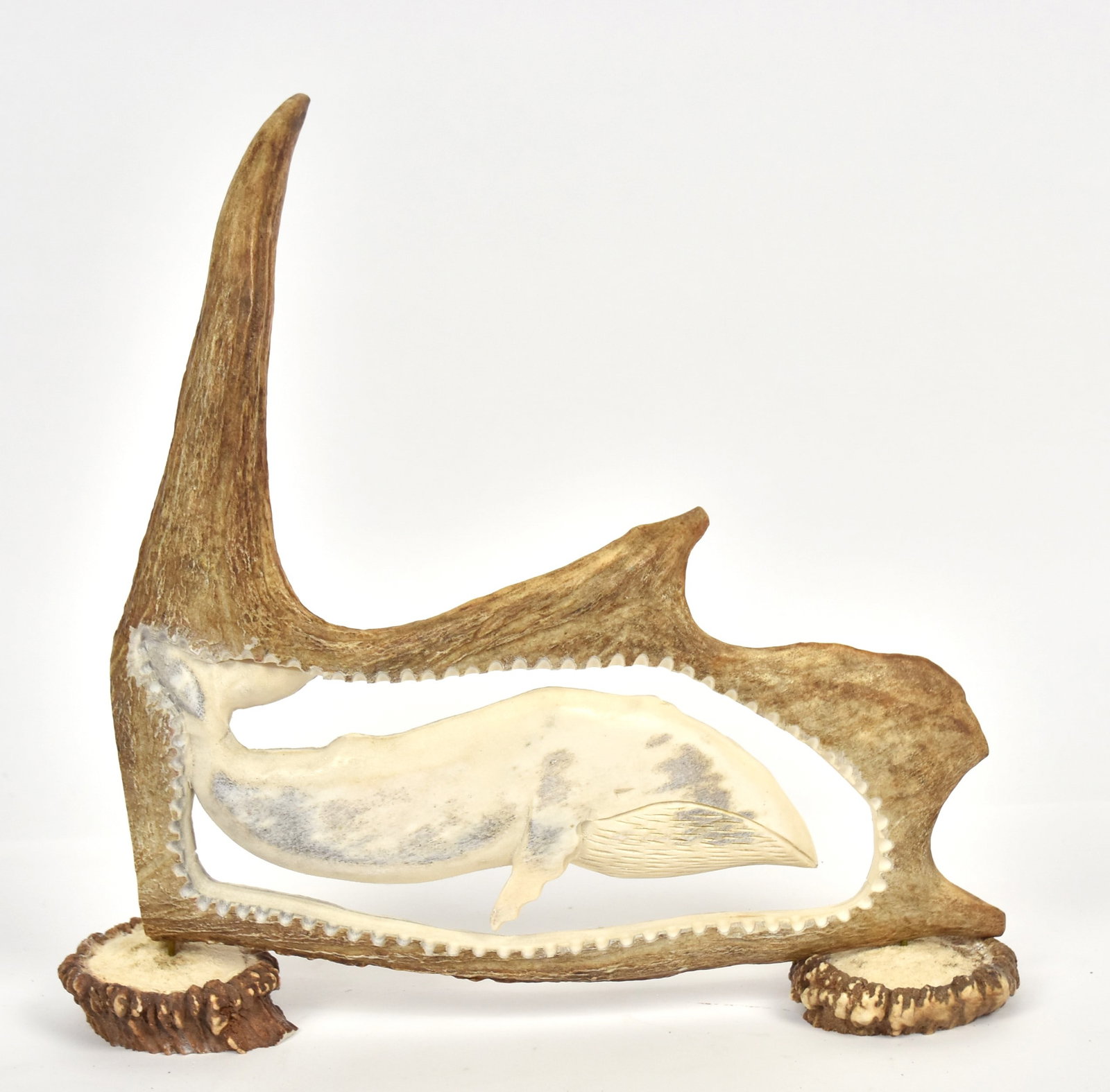 Artist Signed Caribou Antler Sculpture: Cut-out and deep relief carved baleen whale with antler butt bases, artist monogram AT on end, 14 x 3 x 13" high. Condition Fine.