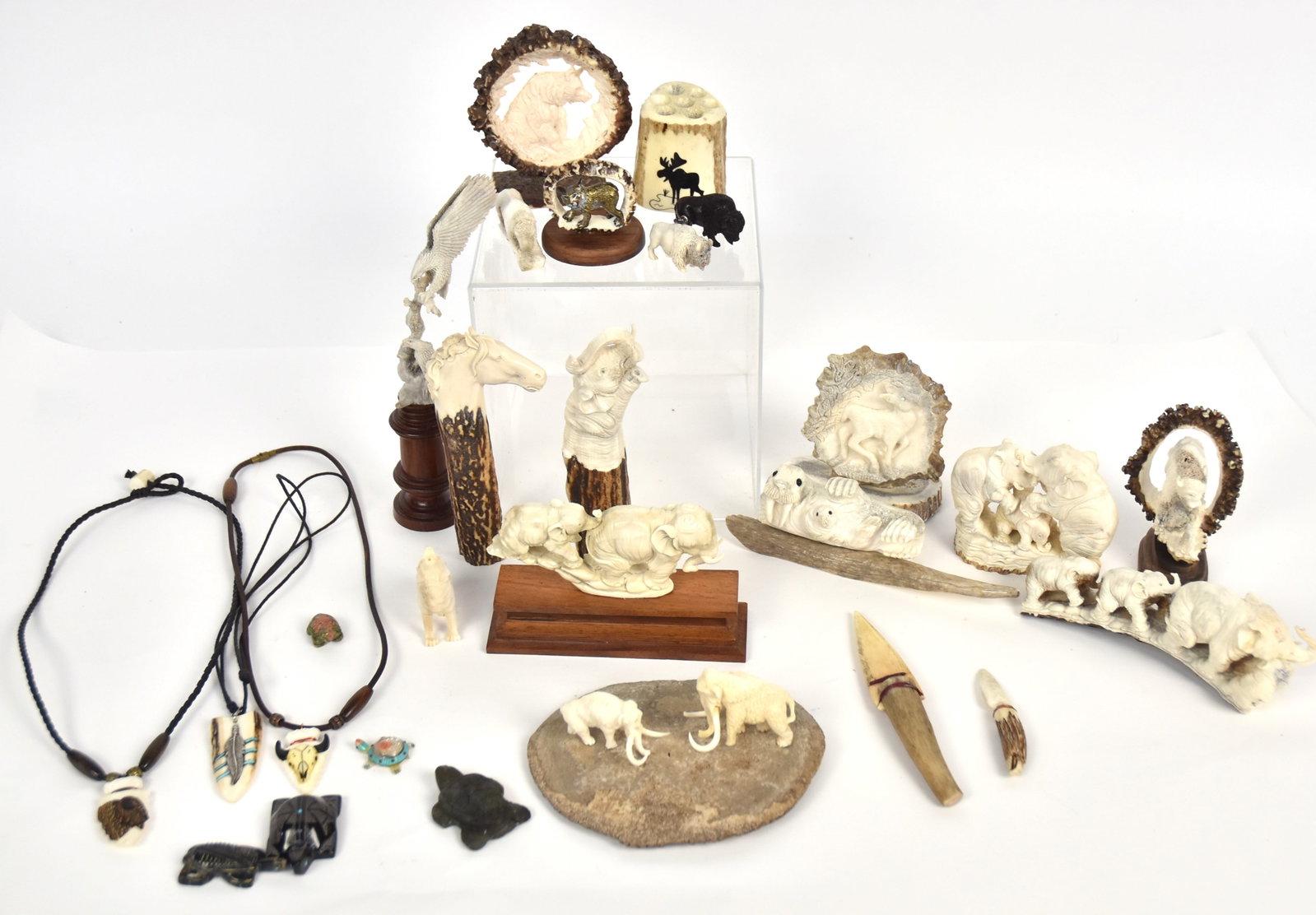 Beautiful Carved Antler Figures Plus: Lot of 26, including the following carved antler figures: pair eagles with fish on rosewood plinth, 8 1/8" high, line of four graduating elephants, 6" long, three elephant, two elephant, one elephant,