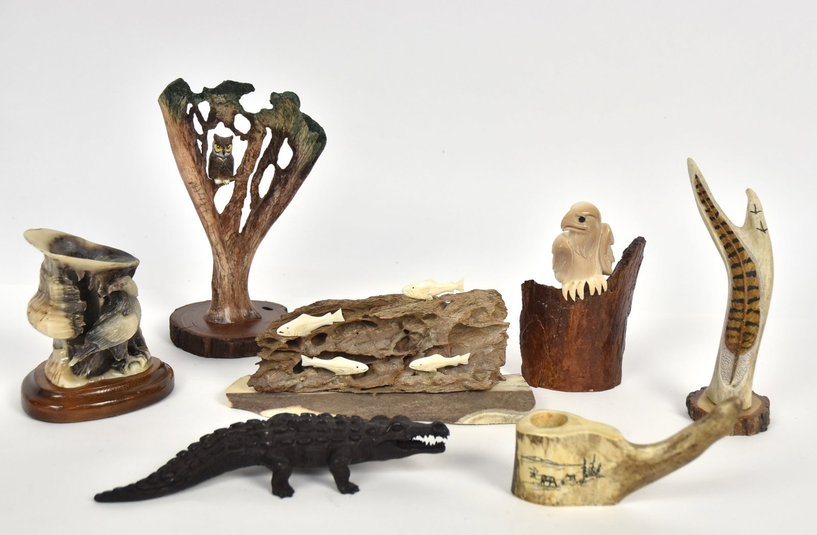 Bone, Horn & Antler Art: Lot of seven, including fossilized whale & walrus bone eagle, 6" high; plus antler carved with feather and painted, on wood base, 7" high; plus deer scapula cut-out and carved with owl in tree, in pol