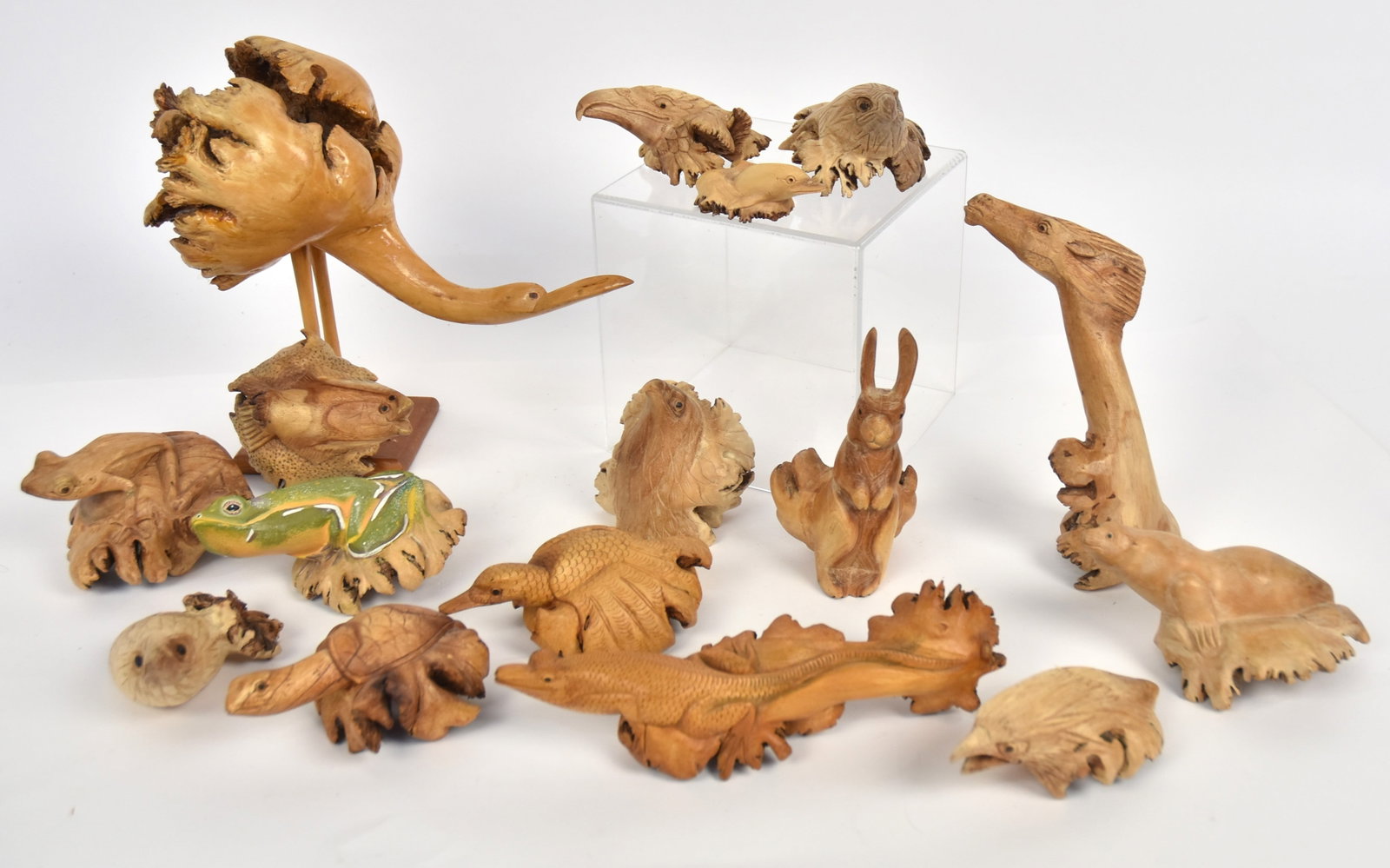 Root Carvings: Lot of 16, all in hardwood roots, subjects include eagles and other birds,lizars, frogs, turtle, seal, rabbit, fish, giraffe, and porpoise. Largest is irca 9" high. Condition All Fine.