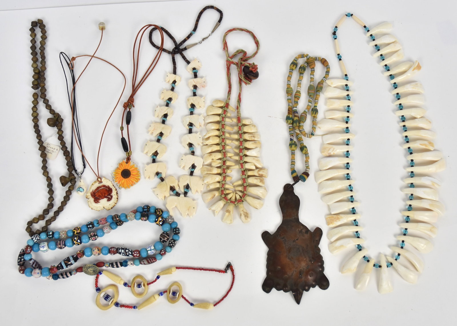 Ten Necklaces: Carved bone and antler, bead work, bison teeth and more. Condition VG to Fine.