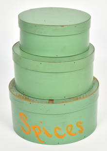 Painted Nested Pantry Boxes: Lidded set of two, spruce & white pine, in original light green painted finish with largest having yellow painted Spices on side, largest is 8 5/8" x 4 1/4" high, smaller is 6 3/4" diameter x 2 3/4"