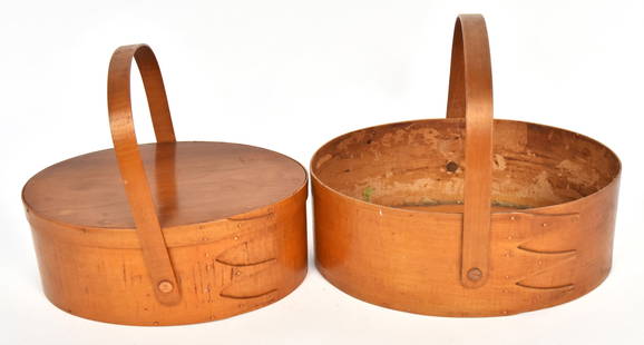 Pair Shaker Sewing Baskets: Both oval spruce and white pine with bentwood swing bale handles, copper rivets and braid, in original varnish finish, larger is 10 5/8 x 7 1/2 x 3 3/4" high and open, smaller is lidded and 9 3/8 x 6