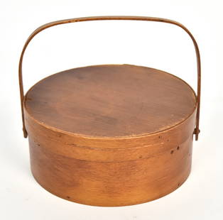 Round Shaker Sewing Basket: Original varnish finished spruce & white pine with original printed paper lining and printed paper label on base with swing bale handle and copper braids & rivets, 6 5/8" diameter x 2 7/8" high.