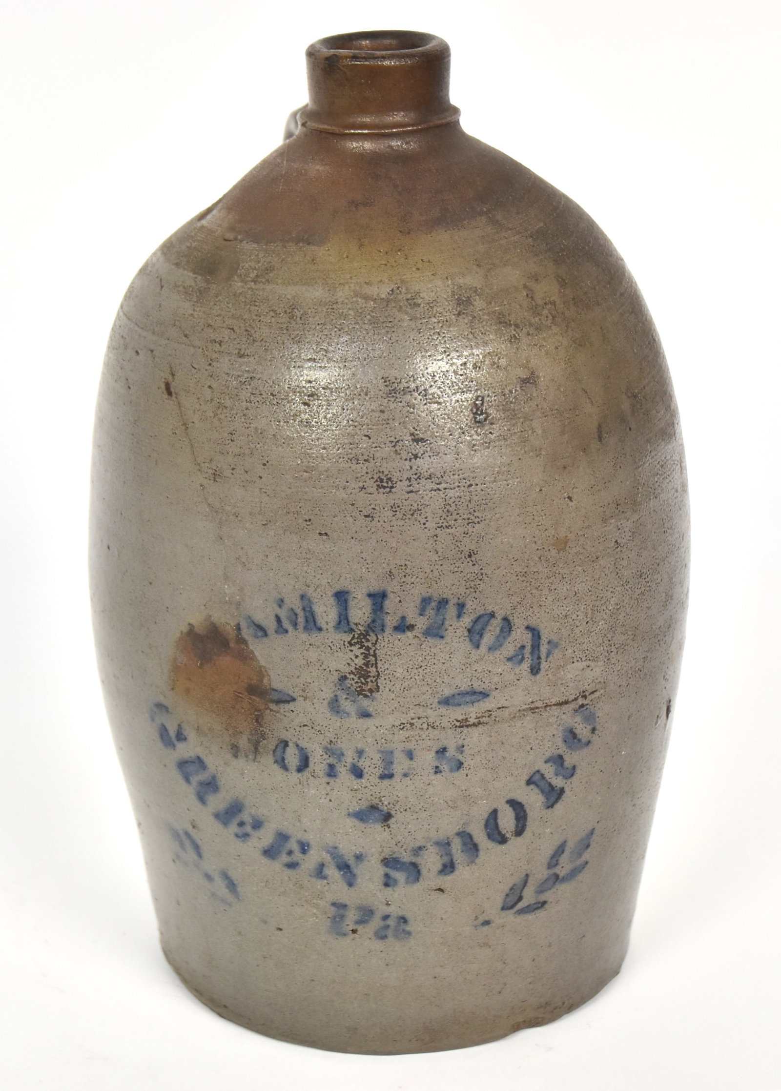Hamilton & Jones Decorated Stoneware Jug: Salt glazed interior & exterior with cobalt stenciled Hamilton/&/Jones/Greensboro/Pa. flanked by cobalt laurel branches, applied C scroll handle, 7" diameter x 11 12" high Condition VG.
