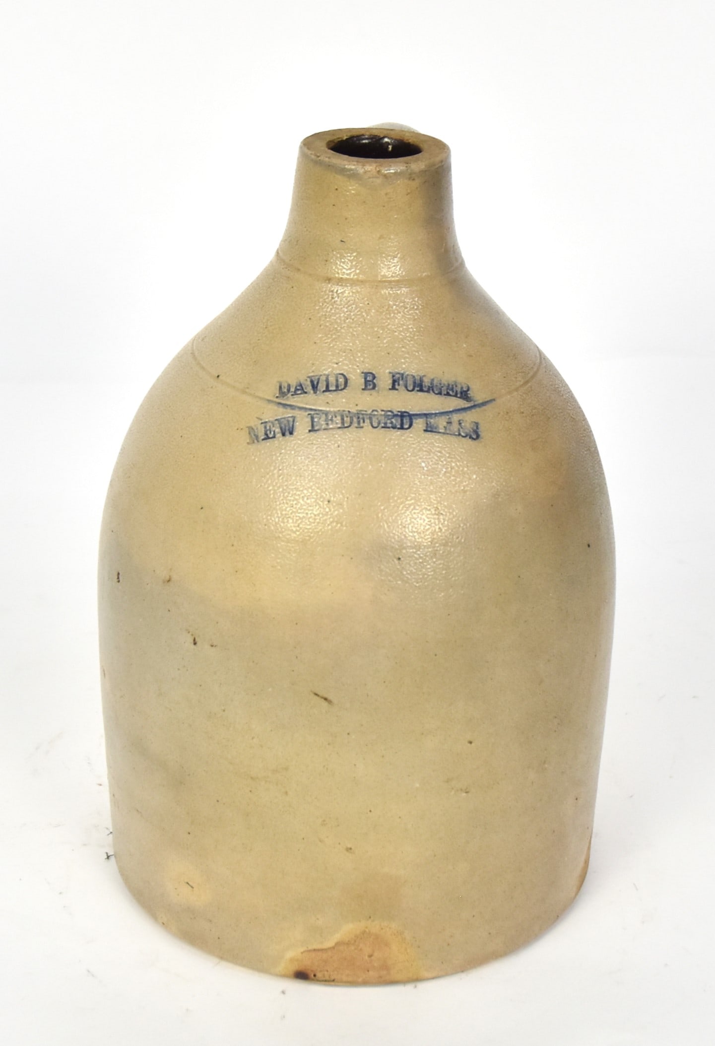 David B. Folger Stoneware Jug: Salt glaze with Albany glazed interior straight sided, stamped on shoulder David B. Folger/New Bedford Mass and brushed with cobalt, applied C scroll handle, 7" diameter x 11" high. Condition Fine.