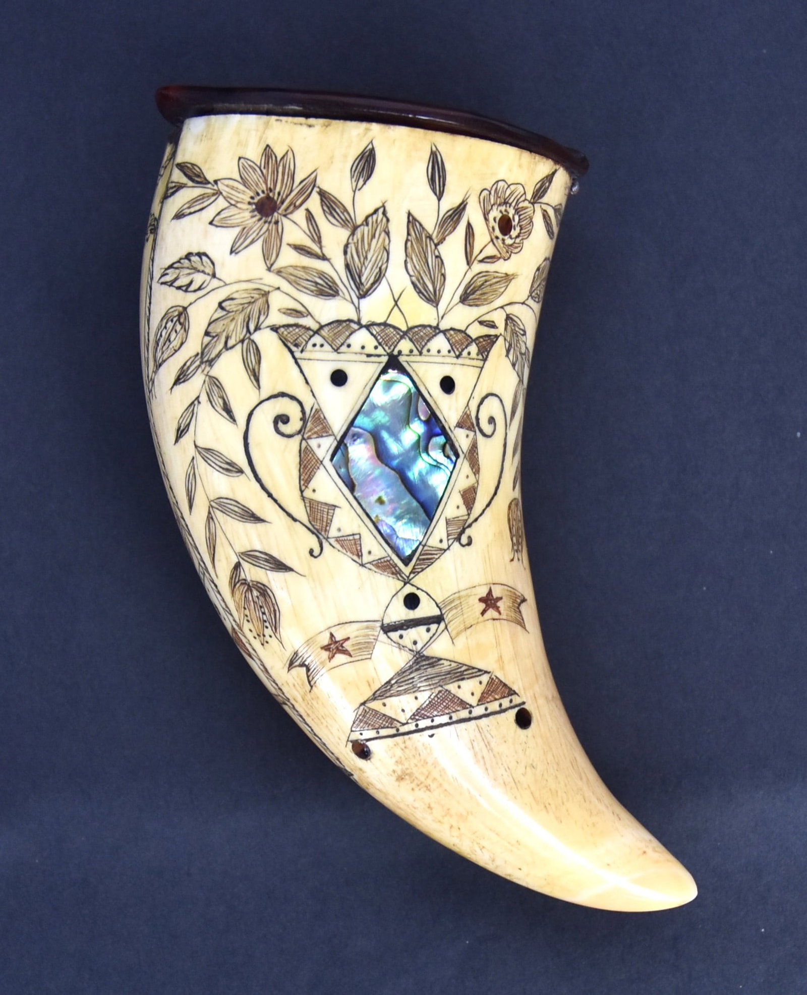 Scrimshaw True Love Boston Whale Tooth: Smaller Sperm whale tooth with lovely scrimshaw engraving with above inscription in heart with arrow, inlaid baleen bird in flight above with laurel wreath in beak vining thistle at base all with scri