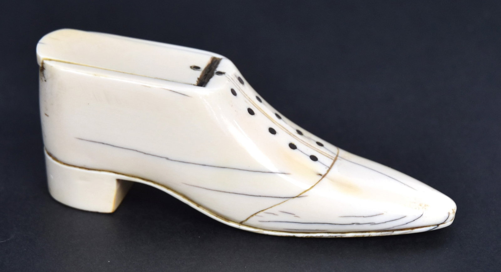 Scrimshaw Figural Snuff Box: Ladies shoe form with baleen inlaid buttons, hinged lid in whale tooth, 4 1/4 x 1/8 x 1 5/8" high. Condition Fine.