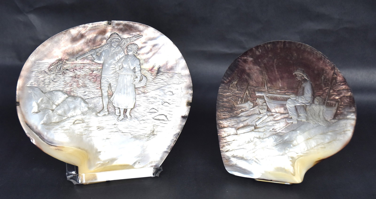 Two Scrimshaw Carved Cameo Shells: Each with nautical scene, 6 1/4 x 6 1/2 & 8 x 7 3/8". Condition Fie.