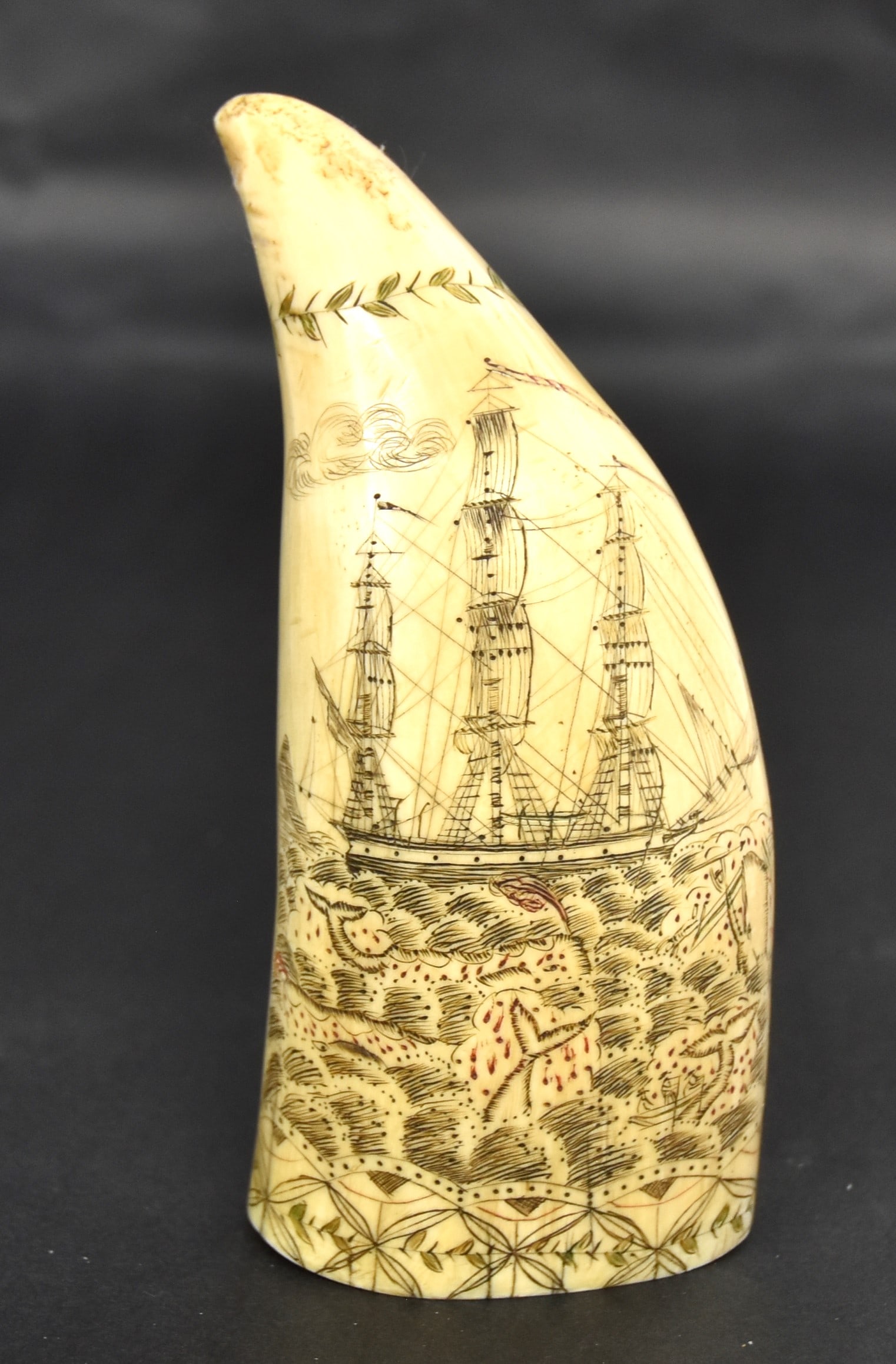 Fine Scrimshaw Sperm Whale Tooth: Engraved on each face with whaler hunt scene with four whales and two whale boats, one being broken in half by angry whale, reverse with lady holding left end ribbon banner with Liberty/Justice with a