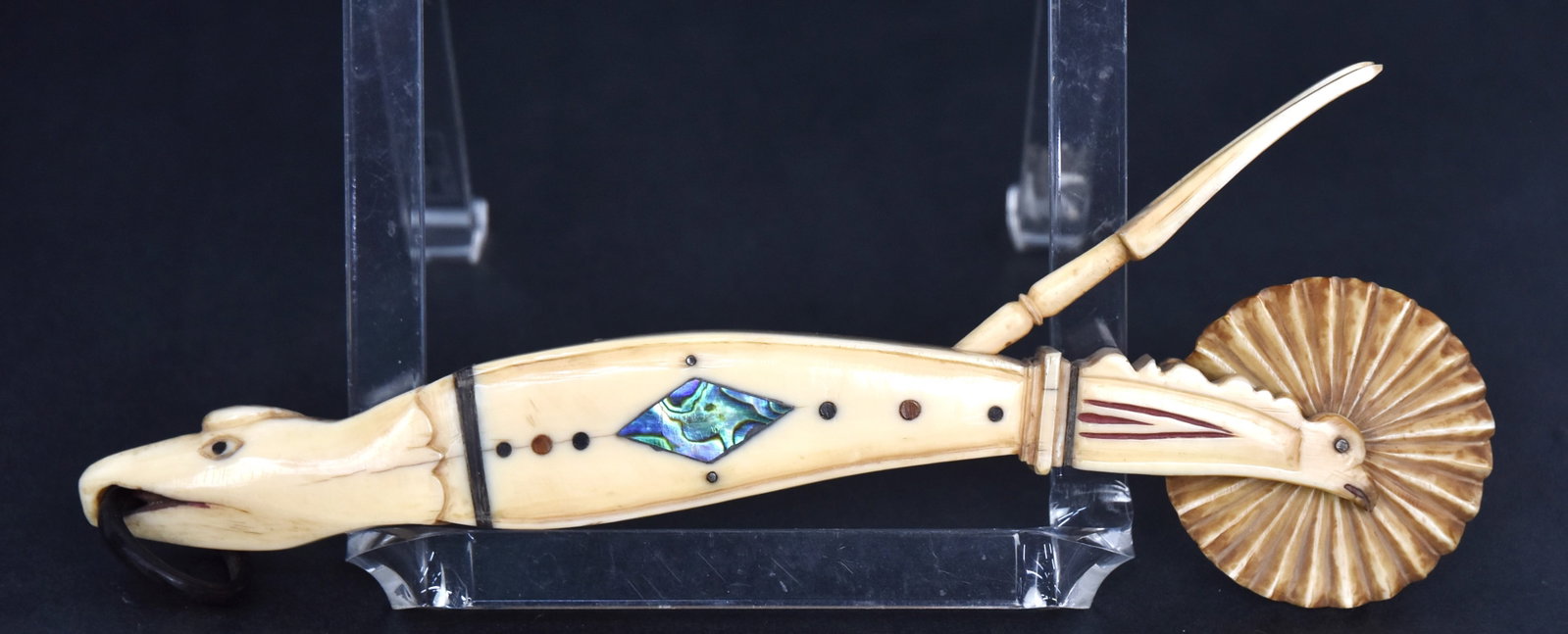 Figural Scrimshaw Jagging Wheel: Pie crimper in whale tooth, baleen, red sealing wax and abalone with single fluting wheel held in place by birds heads shaft with red sealing wax details and two tine testing fork, eagles head termina