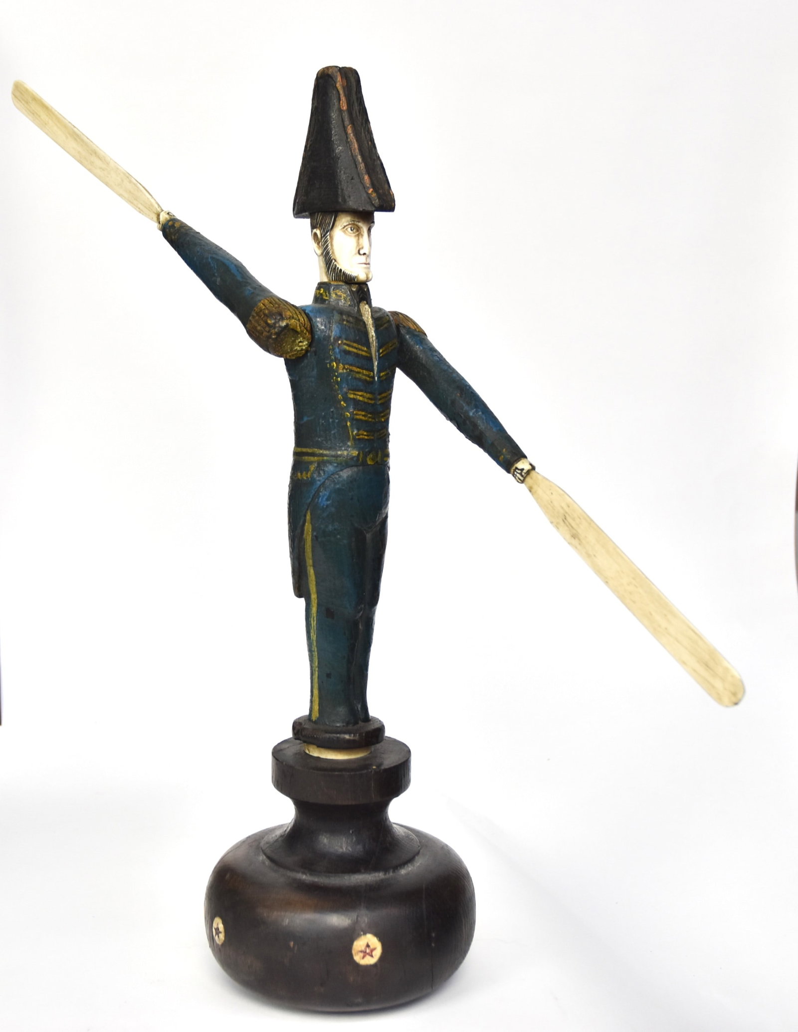 Scrimshaw Folk Art Whirligig: Whale tooth, whale bone and painted wood in the form of early naval officer in blue and gold uniform with fore & aft hat, mounted on turned wood base with inlaid circles with 5-pointed stars, 18" x 16