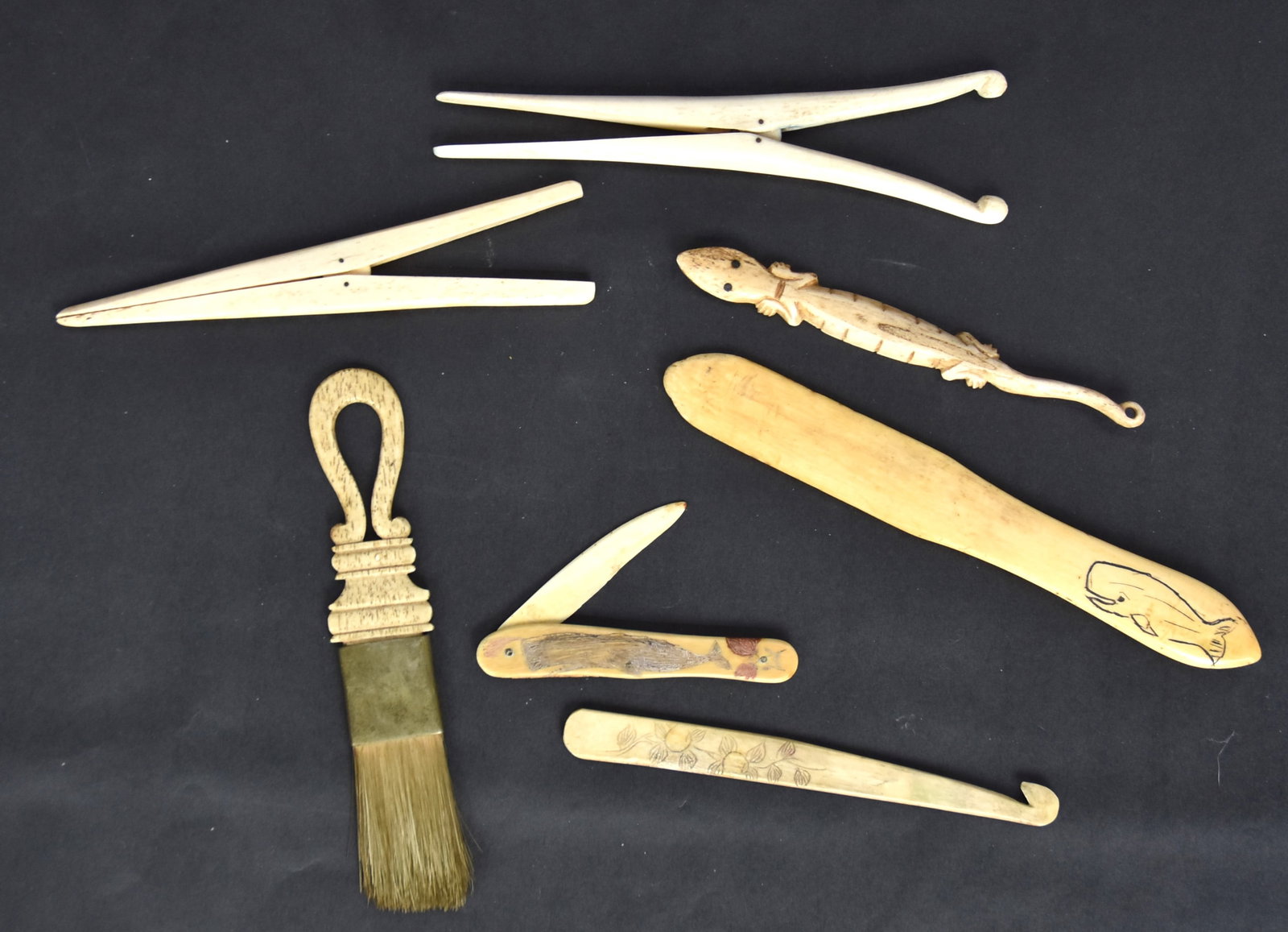Group of Scrimshaw Tools: Lot of seven, all in whale bone, of whale tooth, including shoe horn or letter opener in whale tooth with engraved Sperm whale on grip, fine old polished patina, 7 1/2" long; and the following all in 