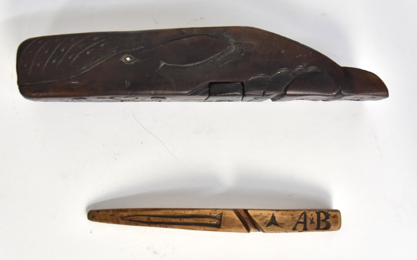 Scrimshaw Boot-Jack Plus: Lot of two including a carved wood folding boot-jack in rosewood in the form of a Sperm whale, folds open with brass hinges, 9 x 3 1/8 x 2 1/4" open, 9 x 2 x 1 3/4" high closed; and n unknown sailor m
