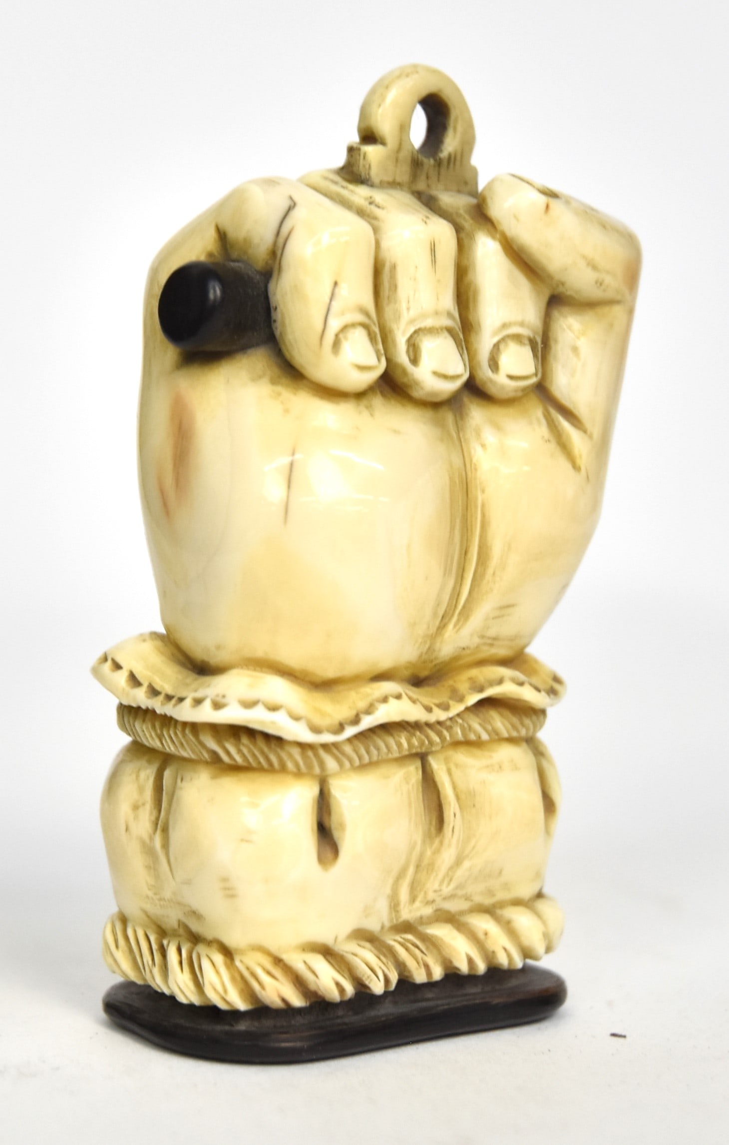 Figural Scrimshaw Snuff Box/ Match Safe: Whale tooth, rosewood, cork and shagreen (ray/shark skin) in the form of clenched fist clutching rosewood rod with lace and roped cuff, rosewood friction fitted lid with cork interior and shagreen top
