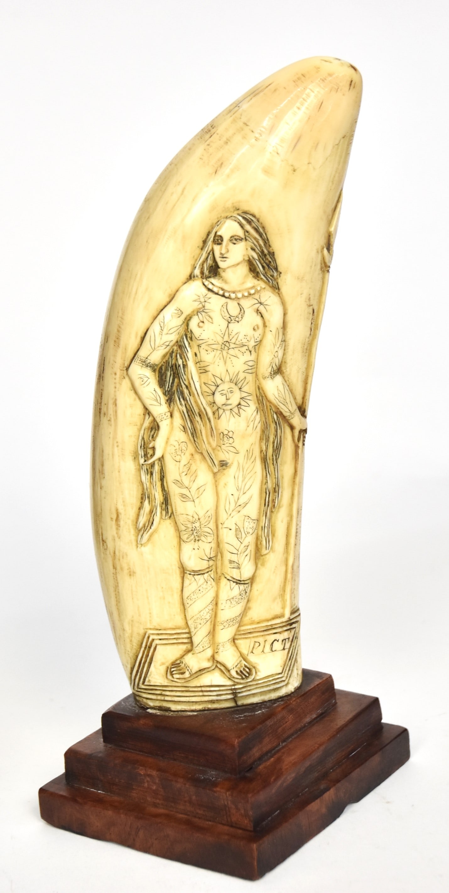 Fine Erotic Scottish Scrimshaw Sperm Whales Tooth: Carved and engraved on one side and engraved on reverse with obverse having nude tattooed lady labeled on base Pict (ancient inhabitants of Scotland) holding spear on left hand; reverse with highly er