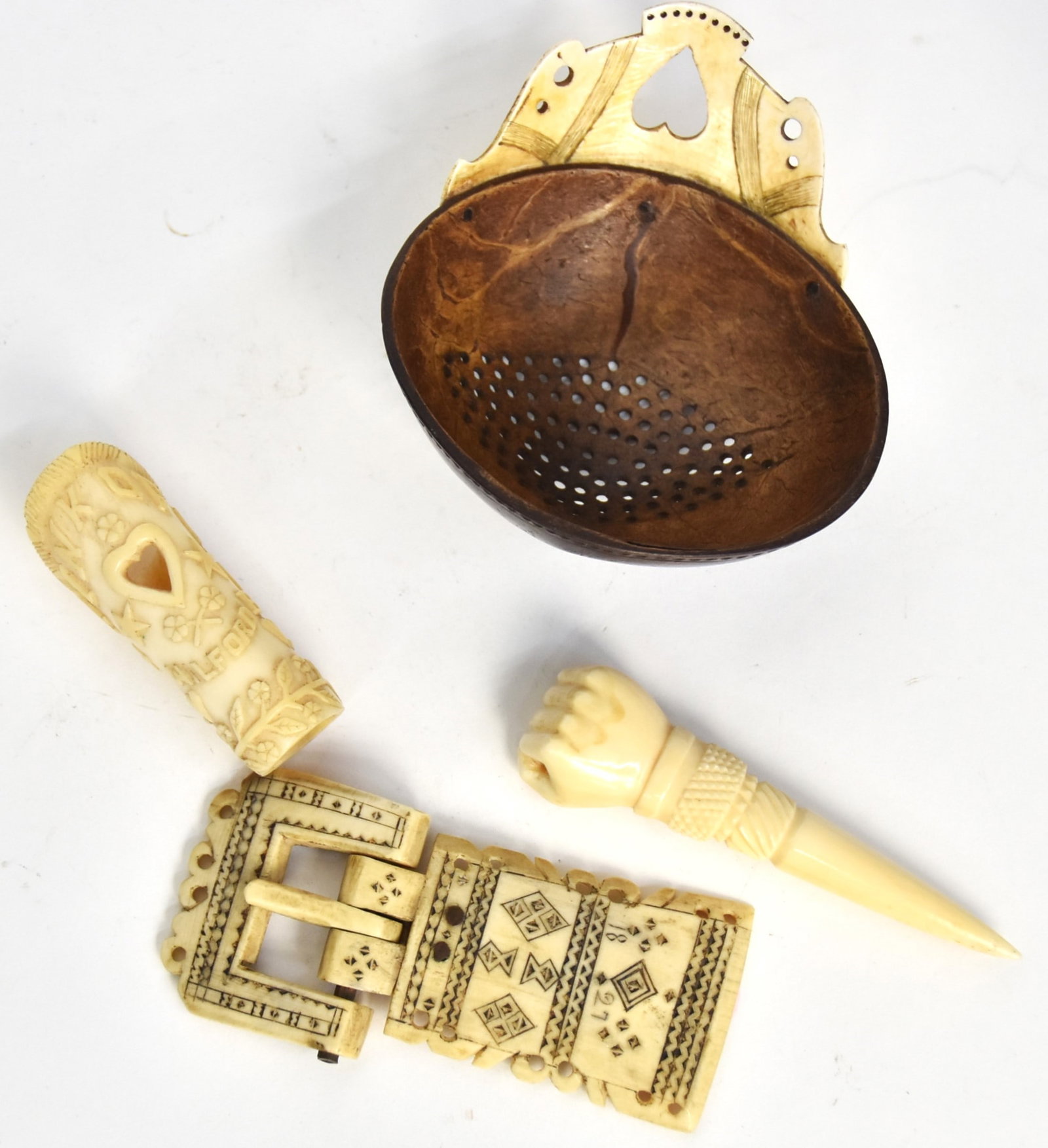 Fine Group of Small Scrimshaw Items: Lot of four, including a bone bollo slide for bandanna with heart cut-out and high relief carving with florals, hearts and more and inscription reading: Think of Me Milford B. May 27, 1913, nice patin