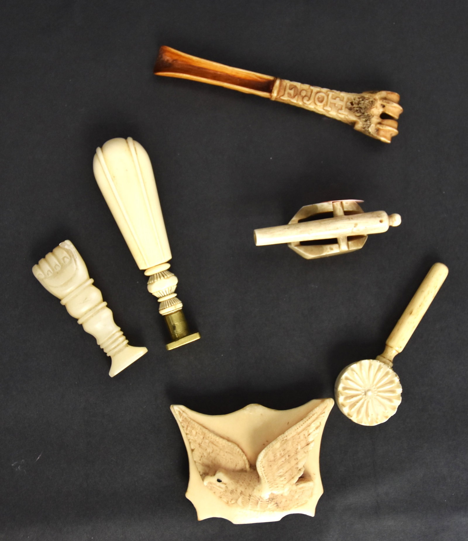 Fine Group of Small Scrimshaw Items: Lot of six, including a toy miniature naval cannon in walrus with nice old patina, 2 1/2 x 7/8 x 1 1/8" high; plus carved walrus belt buckle high relief eagle in flight with inlaid baleen eye, shield 