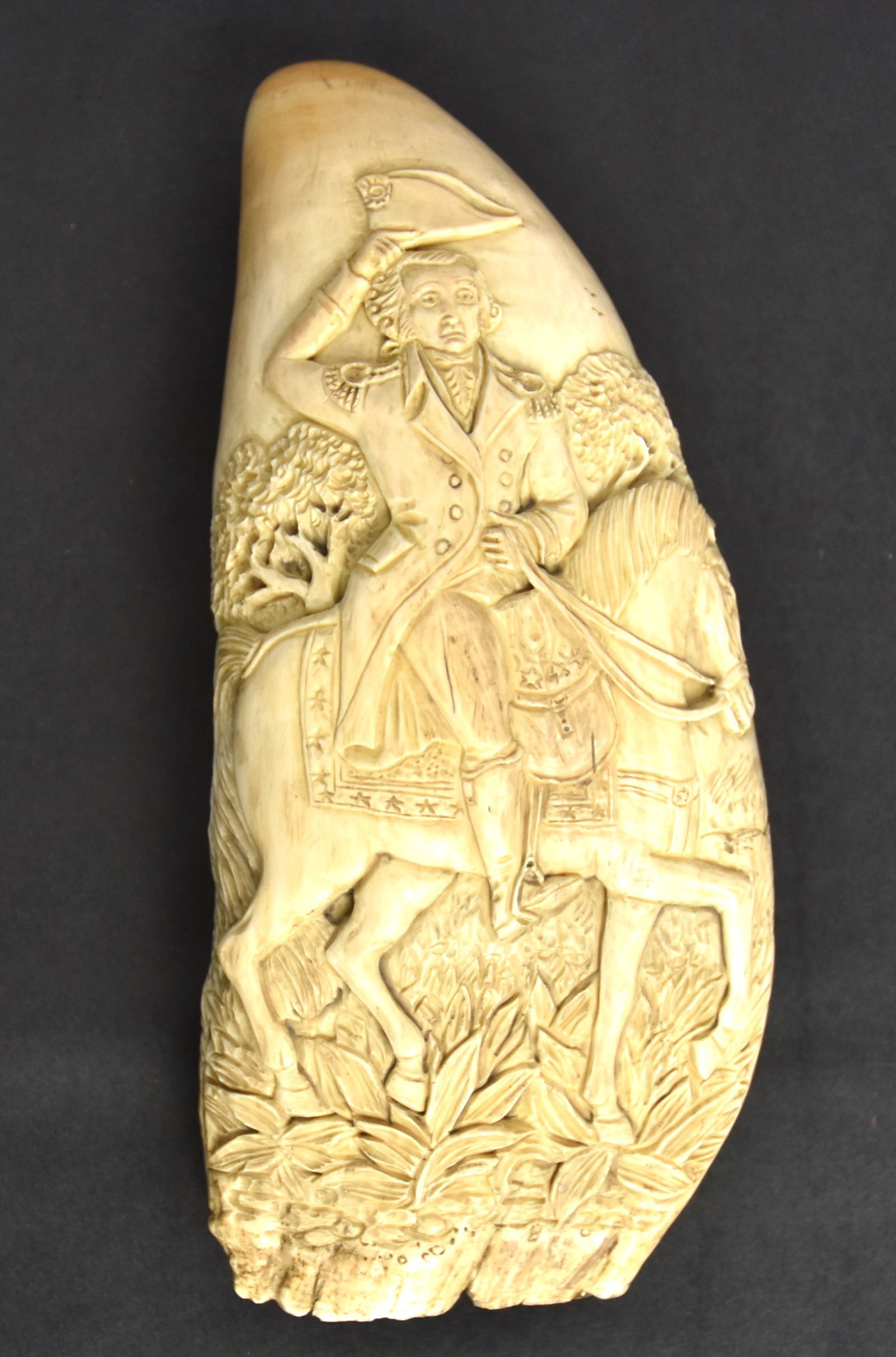 Relief Carved Sperm Whales Tooth: Beautifully carved on each face with obverse having mounted George Washington in uniform with landscape background; reverse with escutcheon with engraved inscription reading: George Washington/Born 11