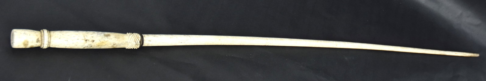 Scrimshaw Walking Stick/Cane: Whale bone and baleen with turned bone knob with carved knot at its base, over baleen ring, over tapered whale bone shaft, all with nice old patina, total length 37 1/2". Condition Fine.