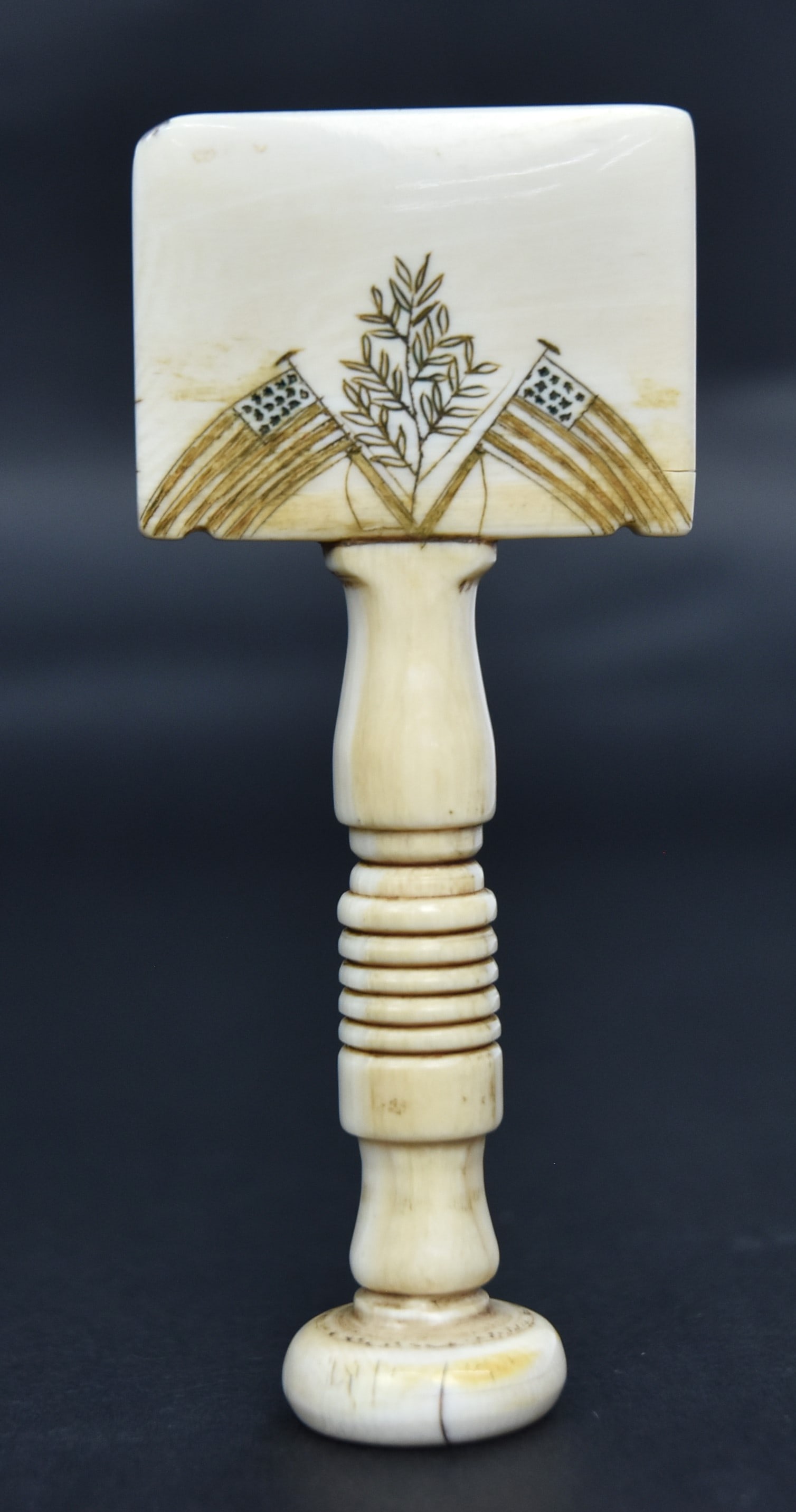 Fine Scrimshaw Seam Rubber: Walrus and baleen with turned grip with terminal engraved with compass star and laurel branches with baleen center, tool end with engraved cross U.S. flags with laurel branches, reverse with crossed h