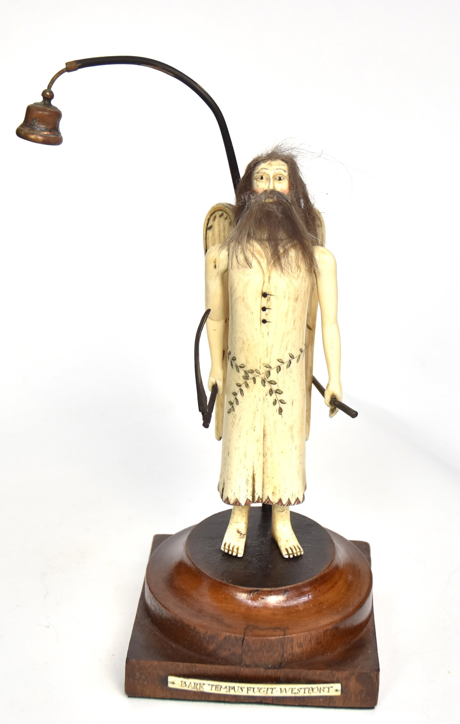 Scrimshaw Figure of Angel of Death: Carved and engraved whale bone, baleen, animal hair, copper and mahogany with 6 1/2" high winged angle of death in whale bone and animal hair, hold scythe and rod with copper bell suspended from bent 