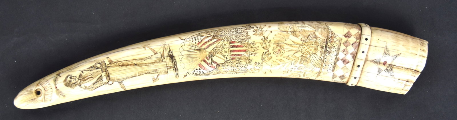 Fine Scrimshaw Walrus Tusk: Engraved on both faces with obverse scene of warship docked at a U.S. coastal fort with inscription below reading: William Rotch/of Fairhaven; above ship initials SJ under clasped hands with United To