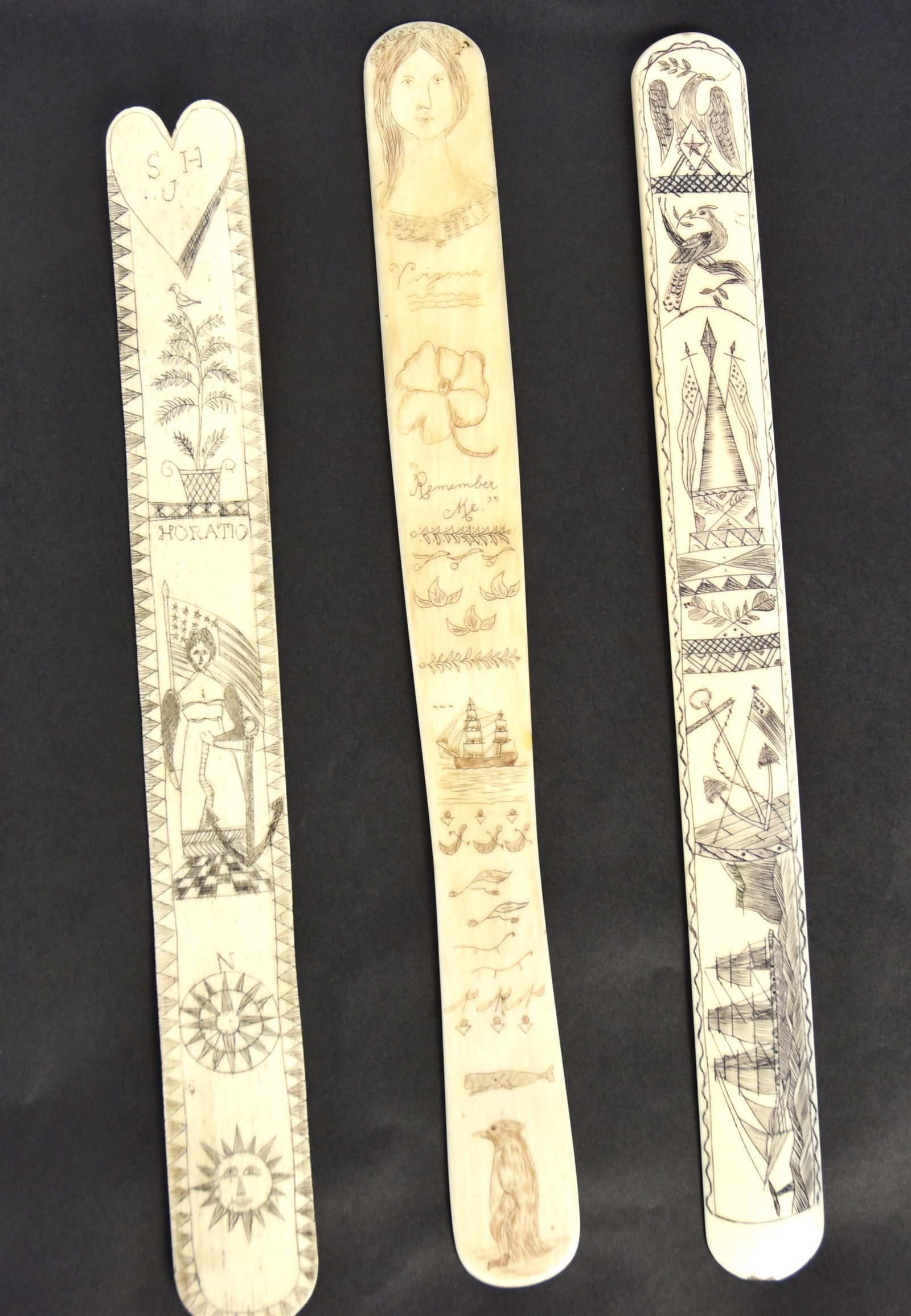 Three Scrimshaw Corset Stays: Also called busks, all in walrus, one with engraved Sperm whale, penguin, flowers two masted ship and bust of young lady, 1 1/8" wide x 10 34" long; plus 2nd with sun with face, over compass star, ove