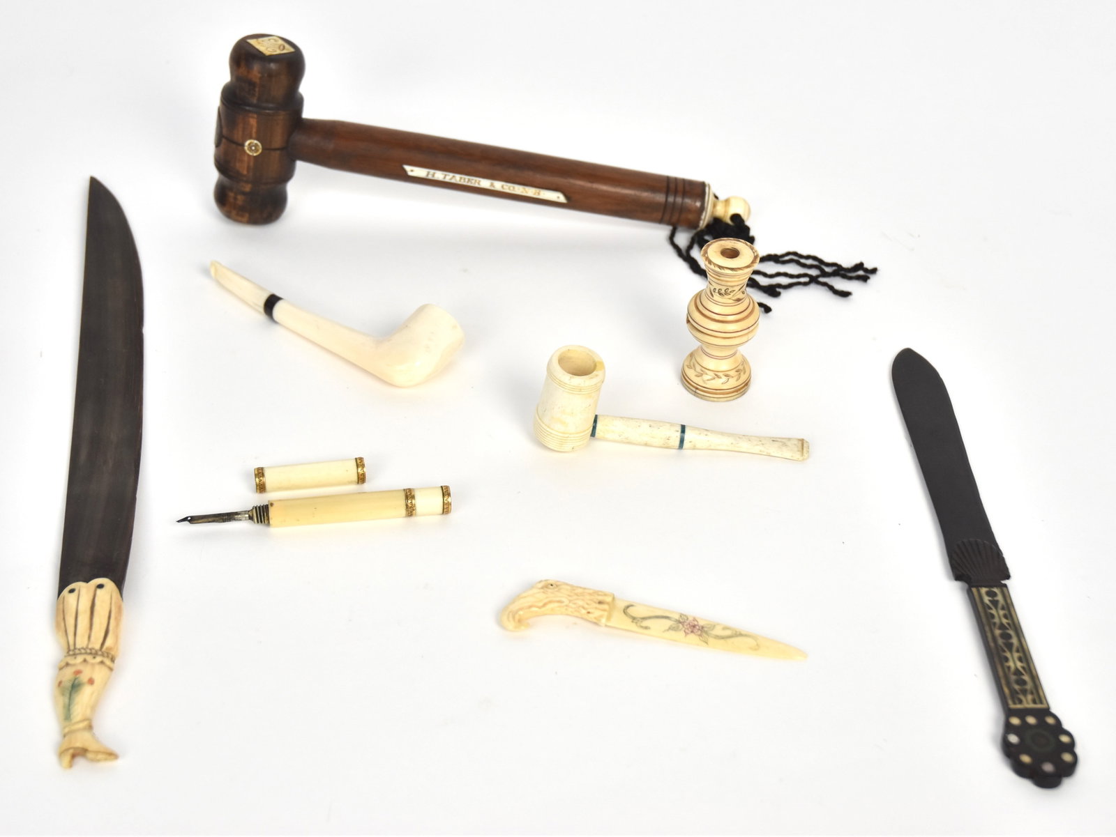 Group of Small Scrimshaw Items: Lot of nine, including figural walrus and horn page turner with horn blade and carved walrus grip in the form of ladies leg with engraved floral on calf and inlaid baleen buttons on shoe, 13 1/8" long