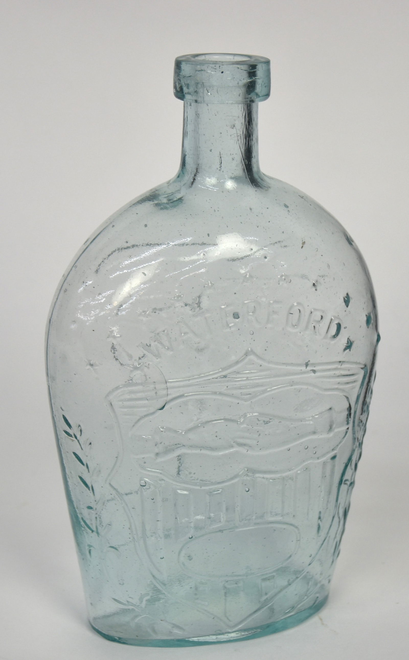 Aqua Waterford Clasped Hands Flask: Obverse with 13 five-pointed stars over and flanking Waterford, over U.S. shield with clasped hands, reverse with eagle in flight right with ribbon banner in beak and laurel branch and arrows in talon