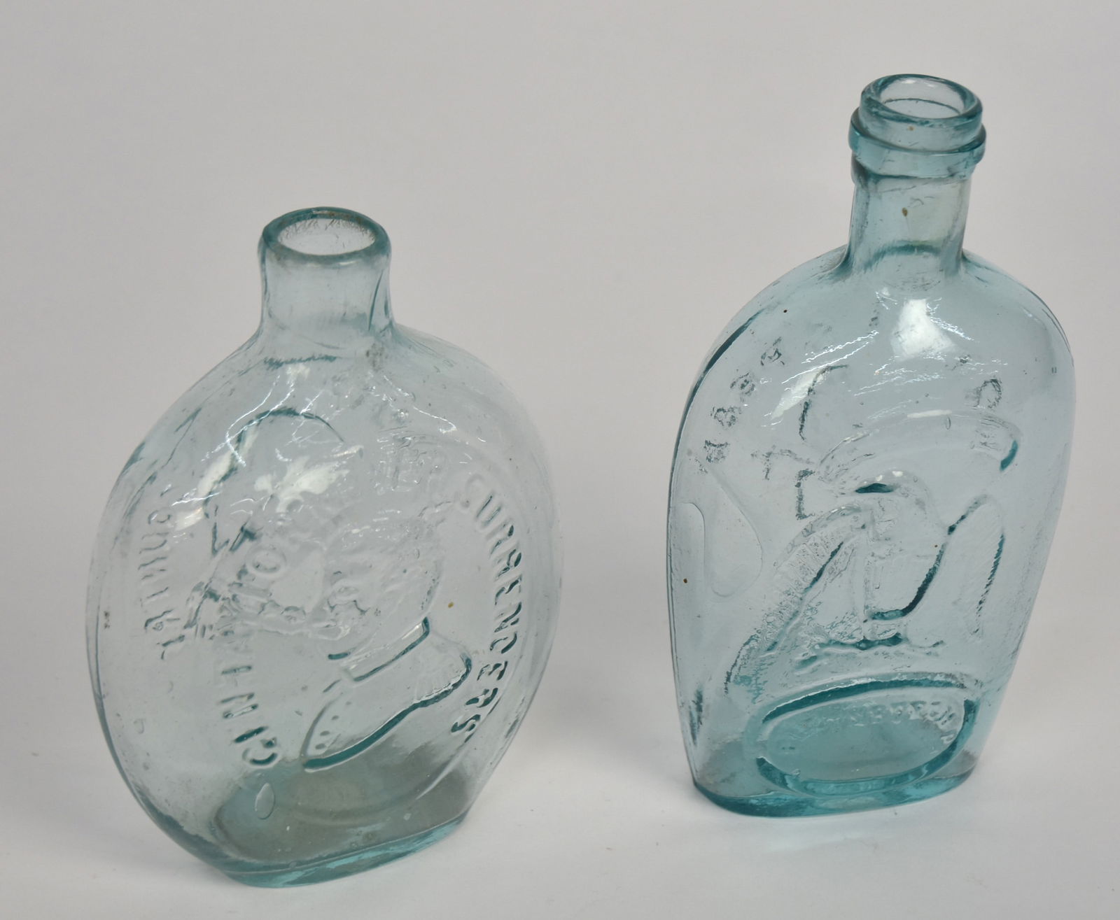Two Aqua Flasks: Washington & Taylor with surrounding inscriptions The Father of His Country & Gen Taylor Never Surrenders, snap pontil on base and fire polished lip, 6 5/8" high; and Pittsburgh Pikes Peak Old Rye Fla
