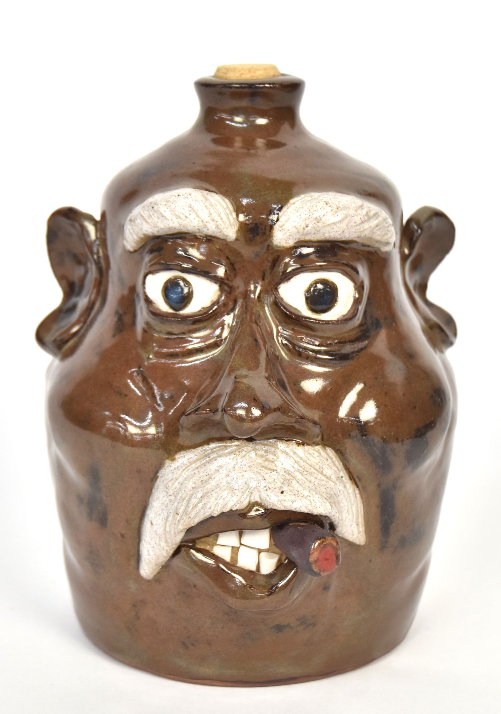 JW Fannin Folk Art Face Jug: Stoneware in brown and white glaze, inscribed on base JW Fannin , 8" high. John W. Fannin. Condition Fine.