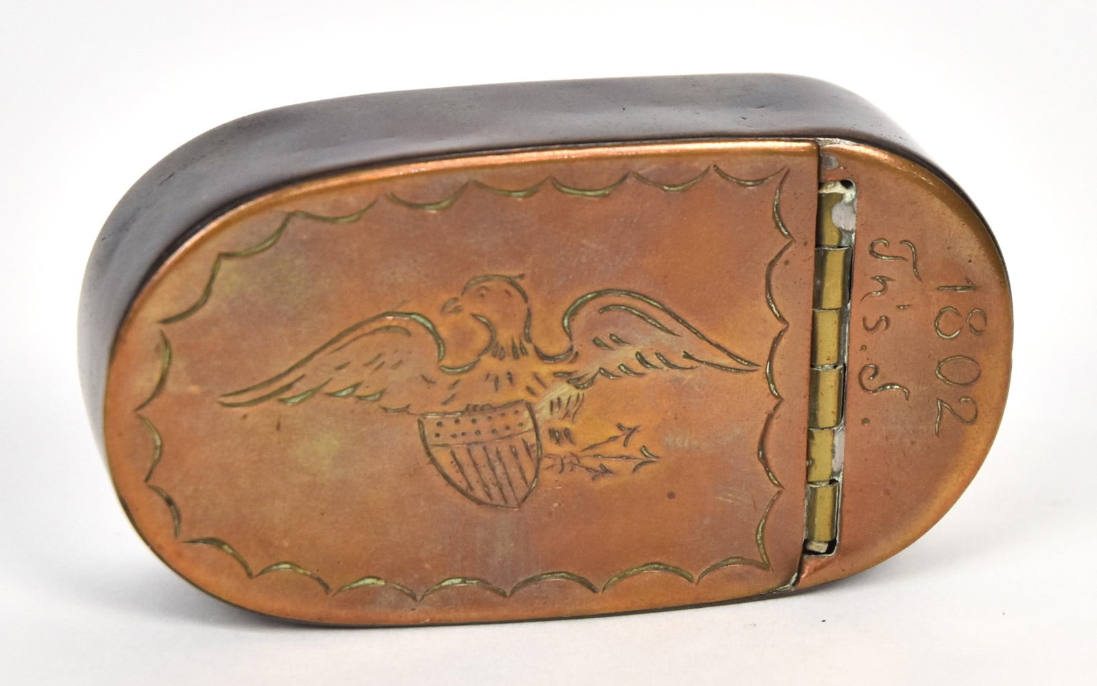 American 1802 Engraved Copper Snuff Box: Oval with hinged lid engraved with spread wing U.S. 13 star shield breasted eagle clutching arrows in talons with date and initials of 1802 Jns. S., nice patina, 3 x 1 58 x 3/4" high. Condition Fine.