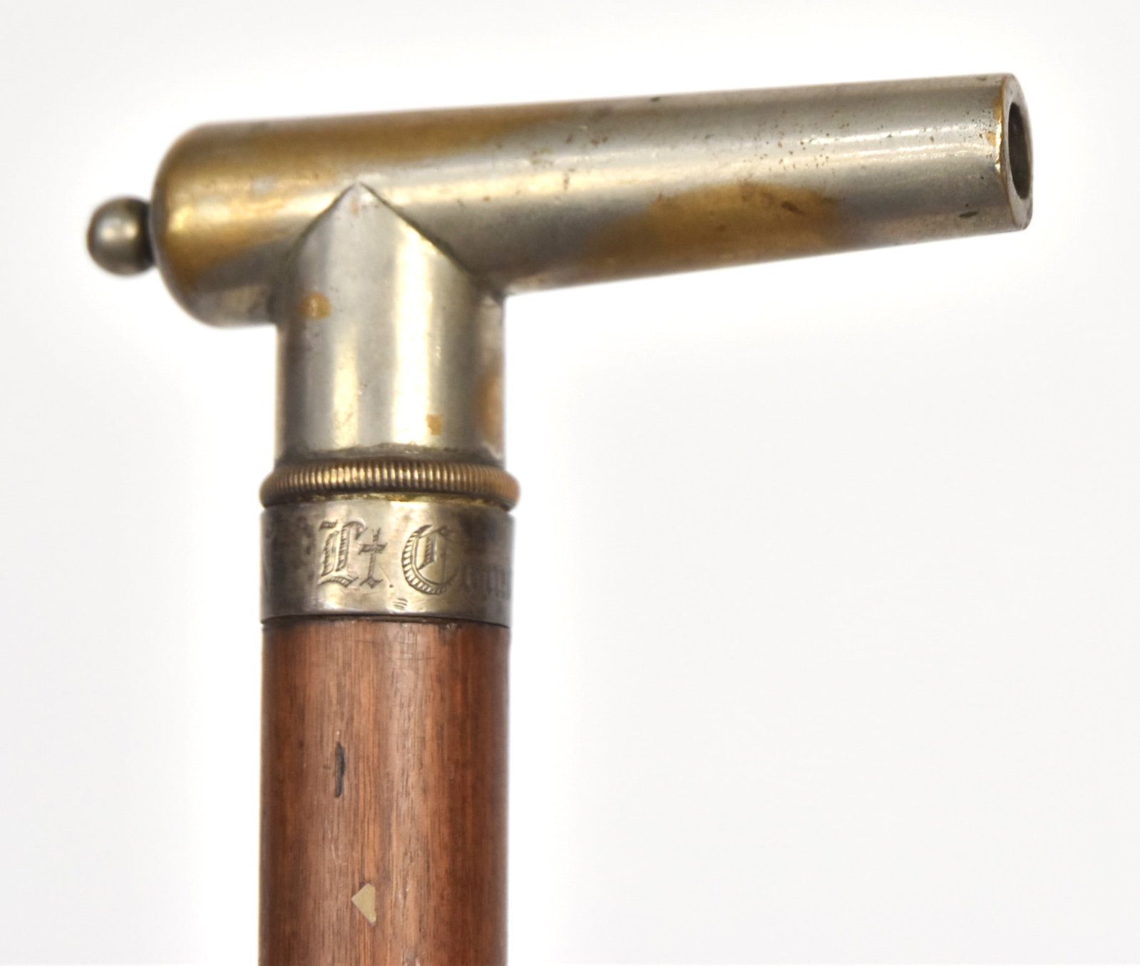 Important USN Presentation Signal Cannon Gadget Cane: Nickle plated brass working cannon with fuse hole, circa .45 caliber, 4" long barrel with engraved silver 1/2" collar reading: Lt. Comdr F.A. Cook U.S.N., mounted on a tapered mahogany shaft with 1 5/